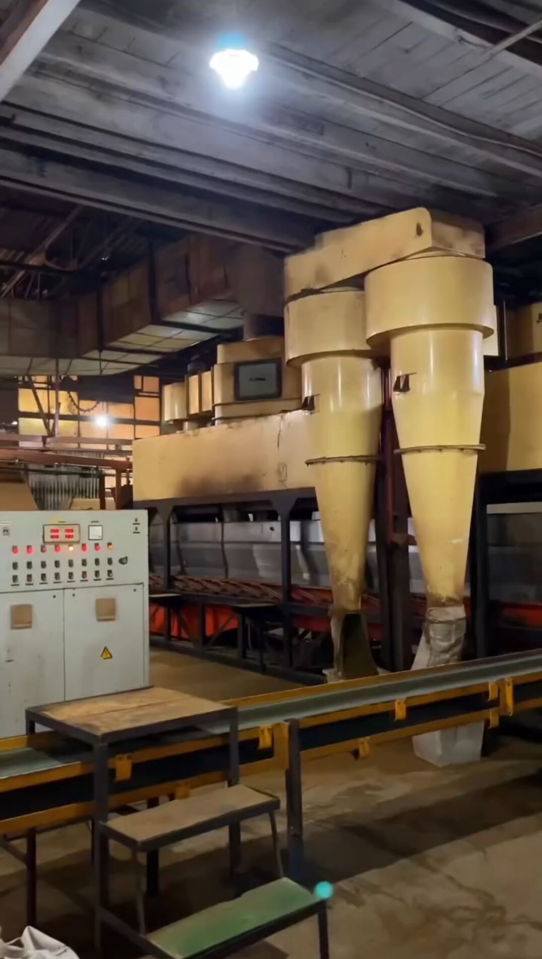 Tea factory floor with machinery and green bags