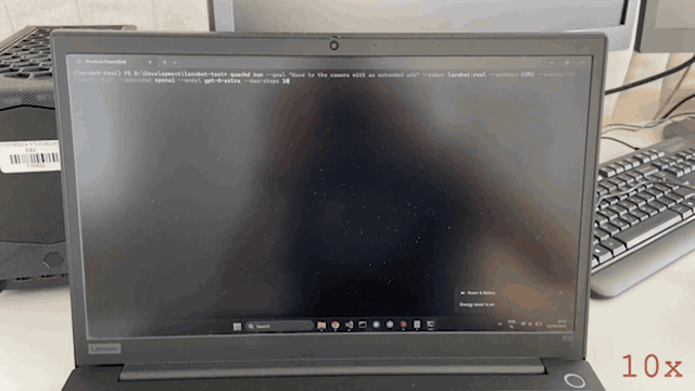A phone recording of a real SO-101 robot arm. It opens on a laptop screen with the quackd command being typed into a terminal, watches the run scroll past, then pans to the bench, where the arm starts folded, raises its shoulder and elbow into an extended pose, rolls its wrist back and forth four times as a wave, returns to centre and stops. A webcam on a stand watches it from table height across a calibration mat.