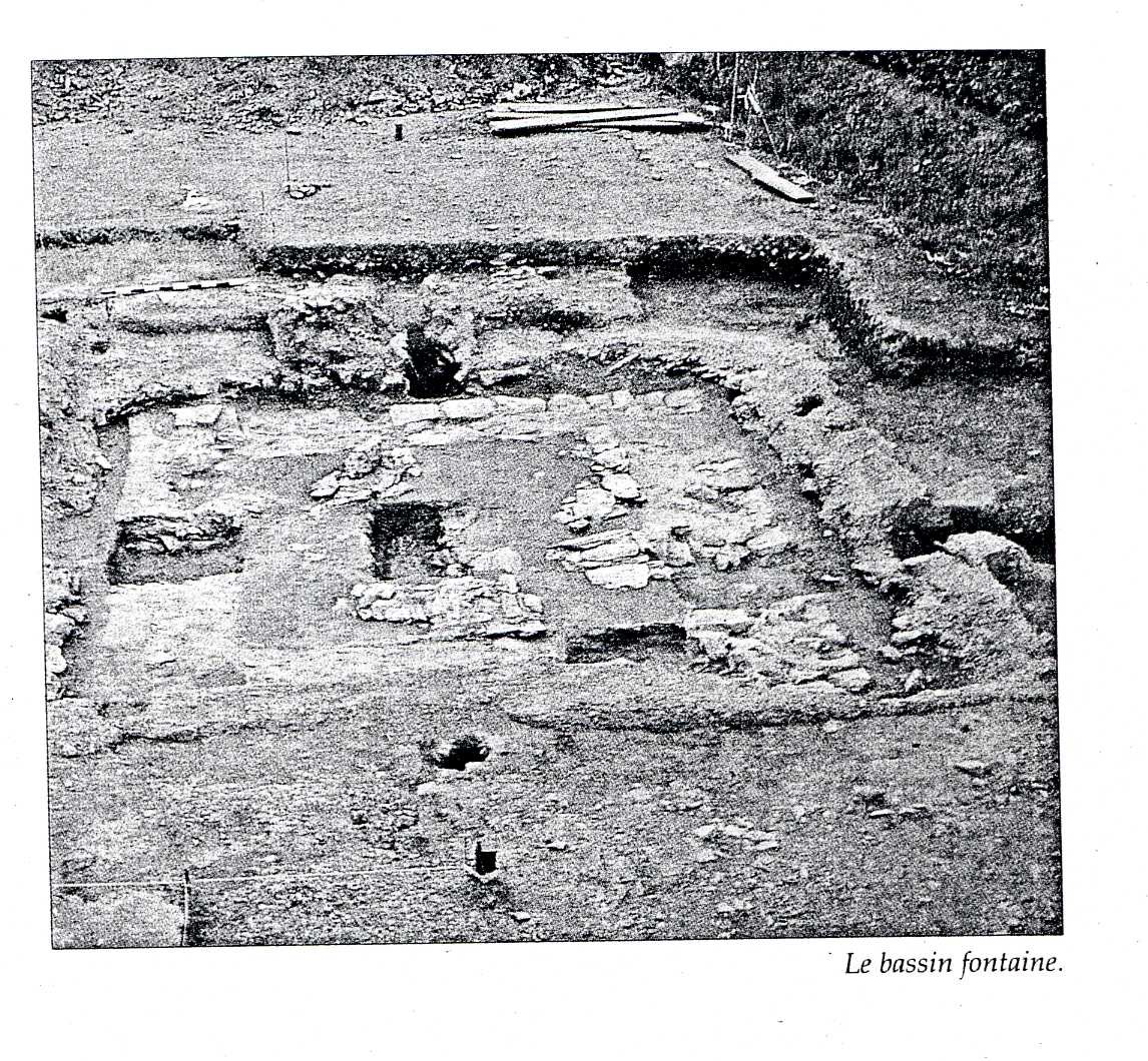 A grainy photograph of an archaeological dig of the fountain bassin.