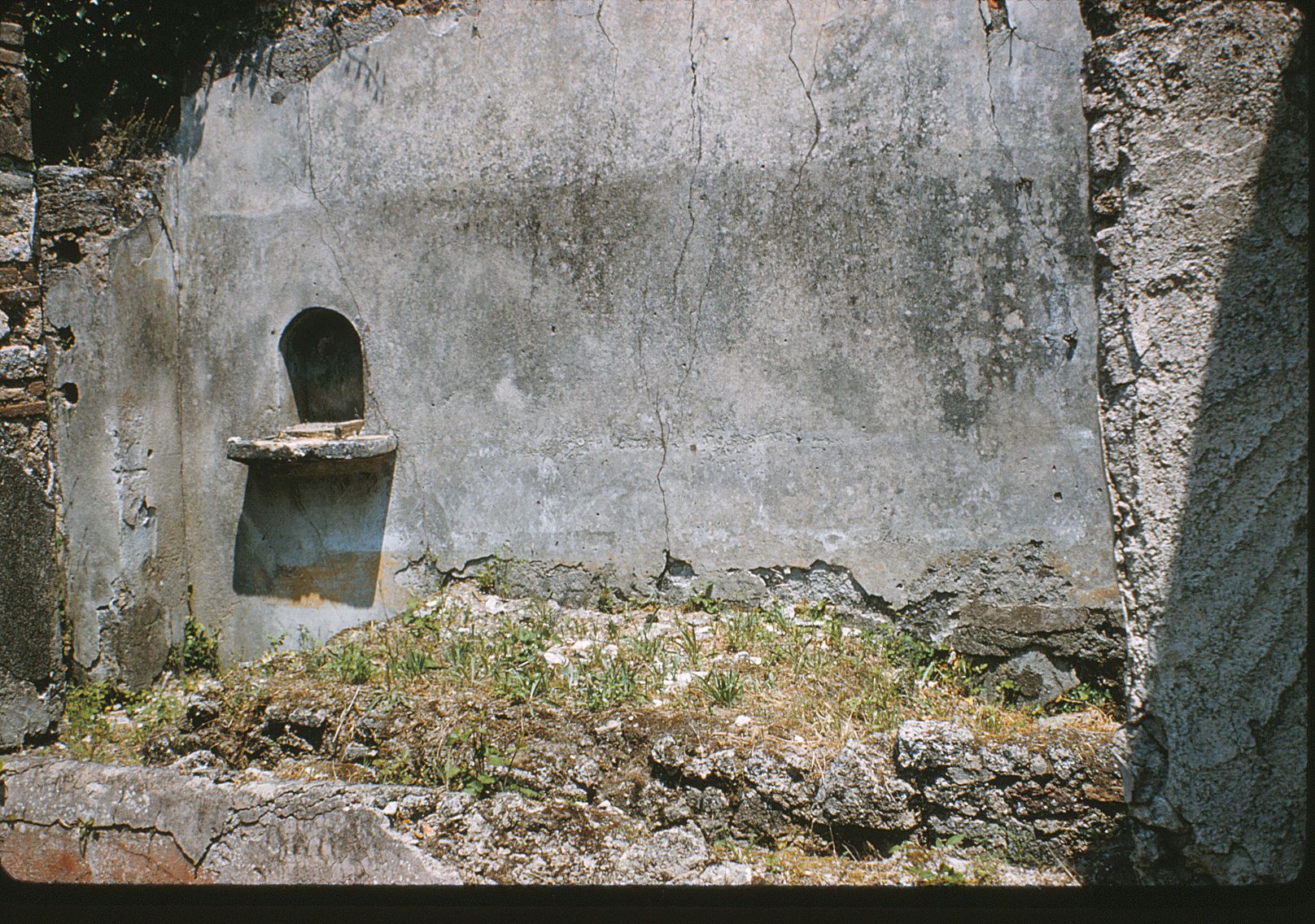 At the extreme left of the east wall was a niche that most likely had been a lararium.
