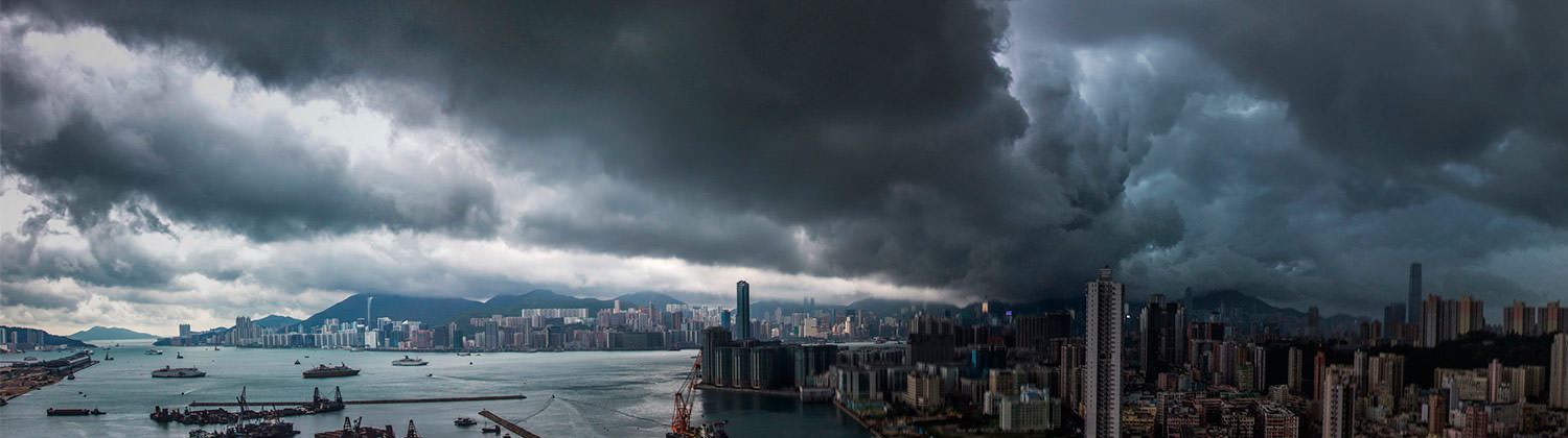 City with looming rain clouds hanging over it