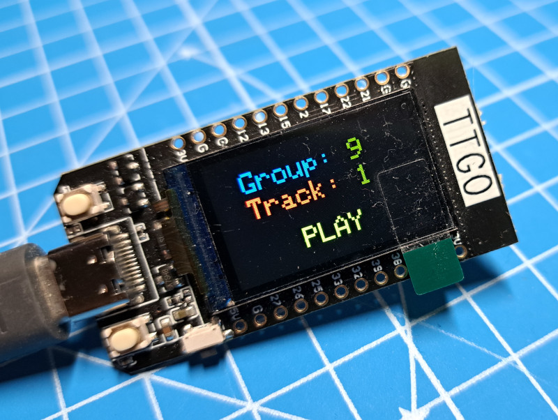 Image of a TTGO showing TRACK and GROUP selections and a PLAY button.