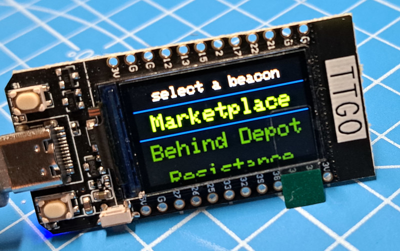 Image of a TTGO showing a 'select a beacon' menu on the display.