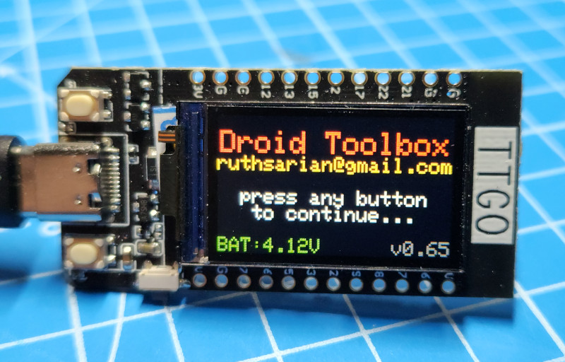 Image of a TTGO with the Droid Toolbox splash screen. It says "Droid Toolbox. Press any key to continue."