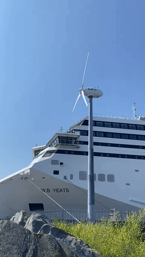 animated gif of windmill spinning with a ferry behind it