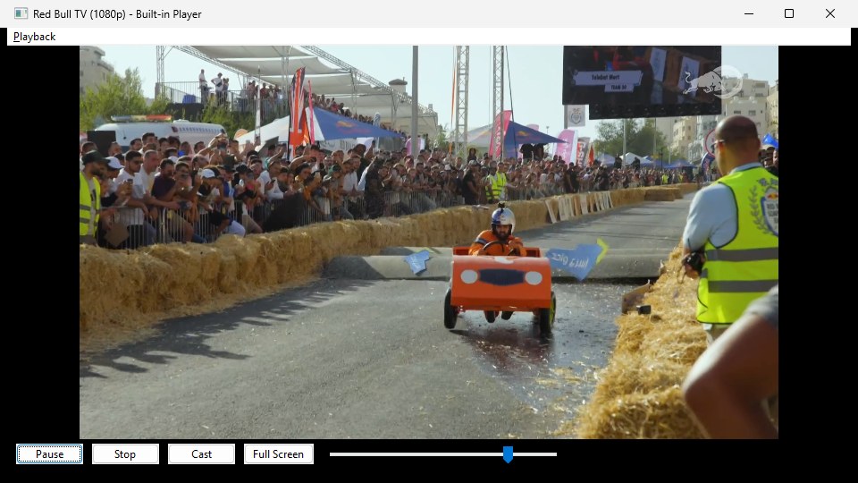 The built-in player window titled "Red Bull TV (1080p) - Built-in Player", showing live video of a soapbox race. A Playback menu sits at the top; Pause, Stop, Cast and Full Screen buttons and a volume slider sit along the bottom.