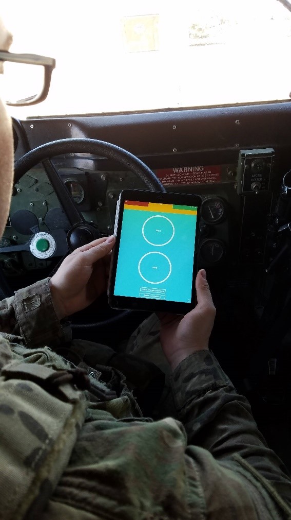 An armored vehicle operator conducts the reaction test on an iPad