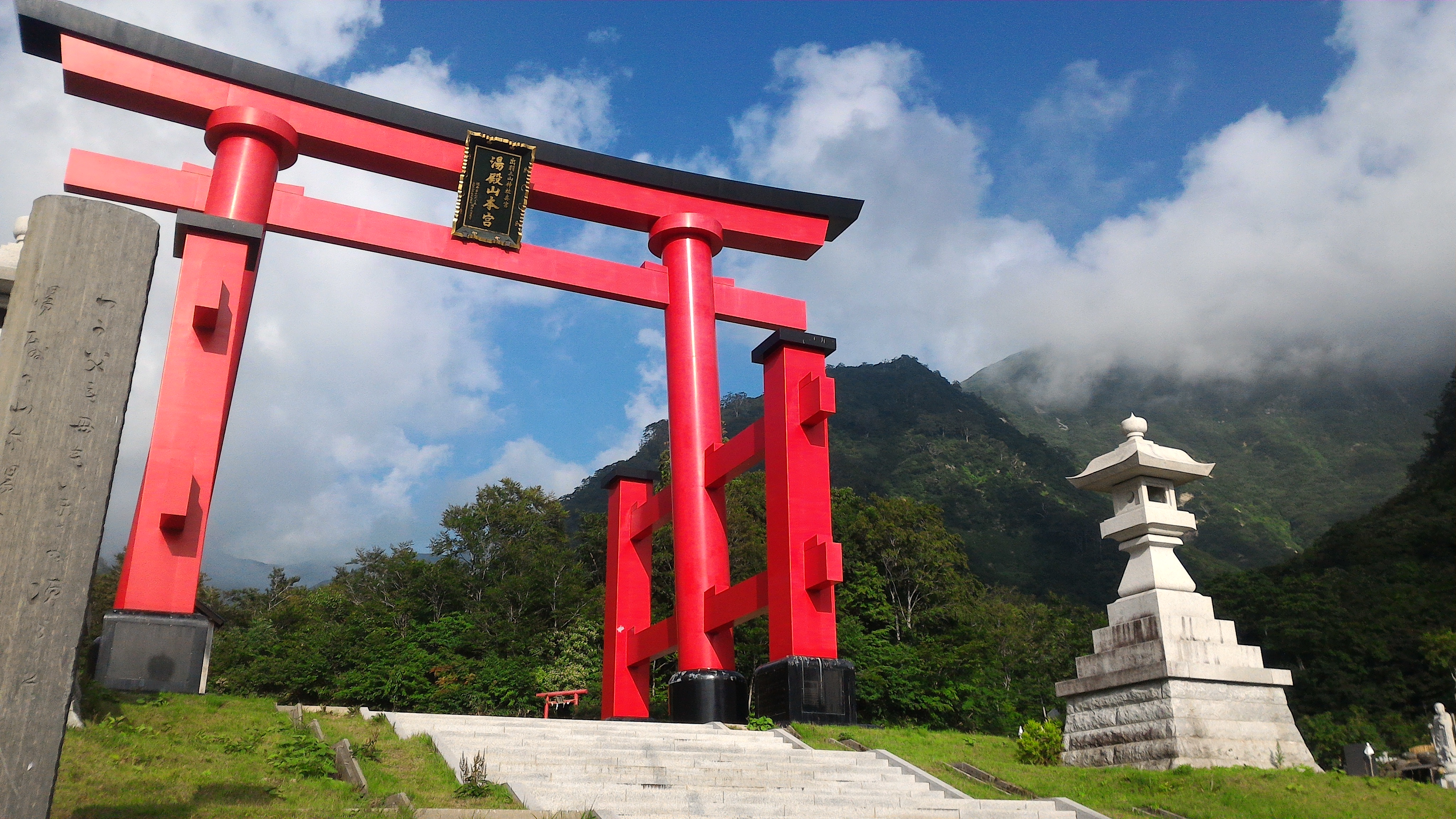 Red torii gate with a blue sky and clouds at Yudono San in Japan by Athena ...