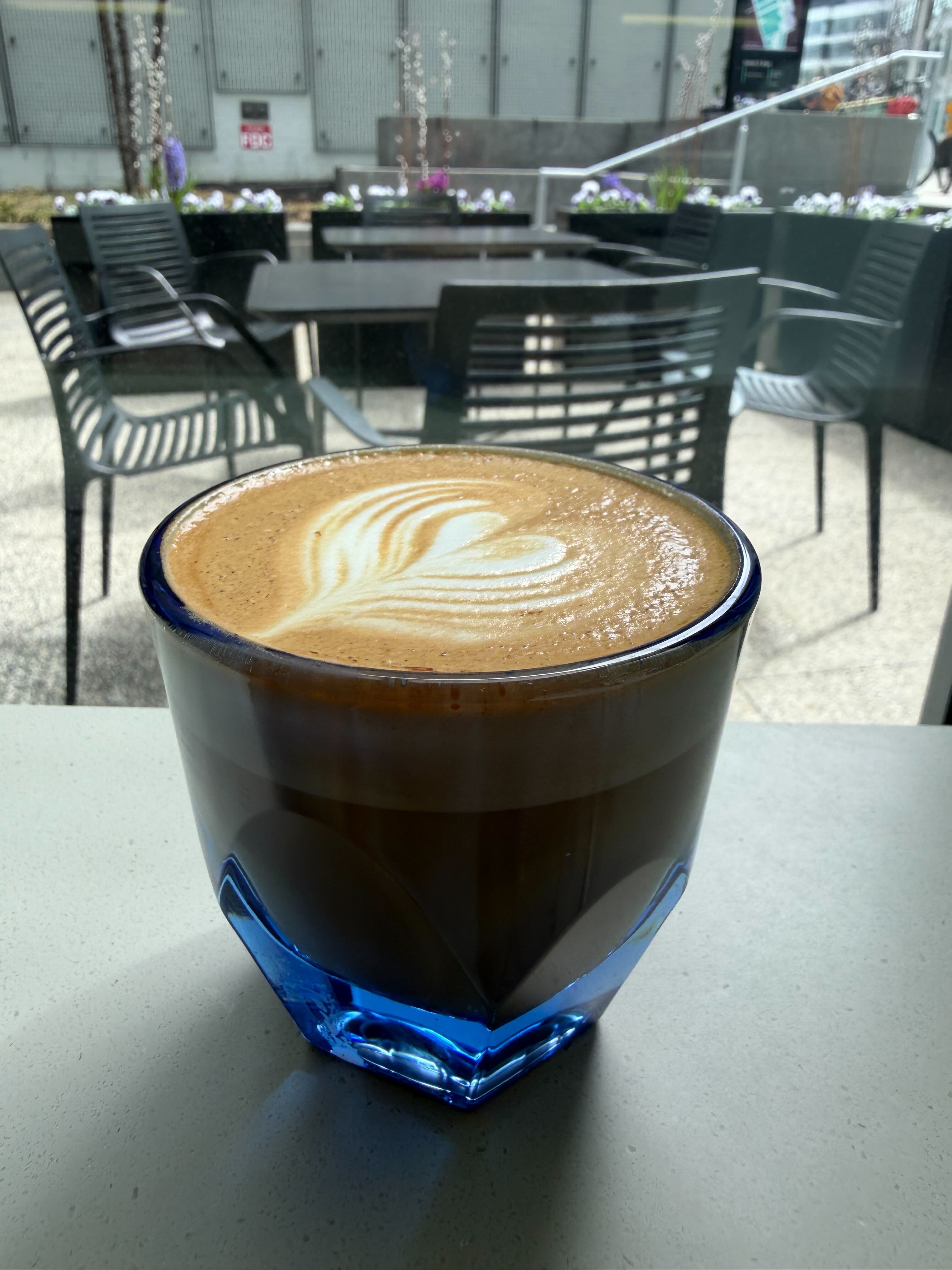 Latte art in a blue glass