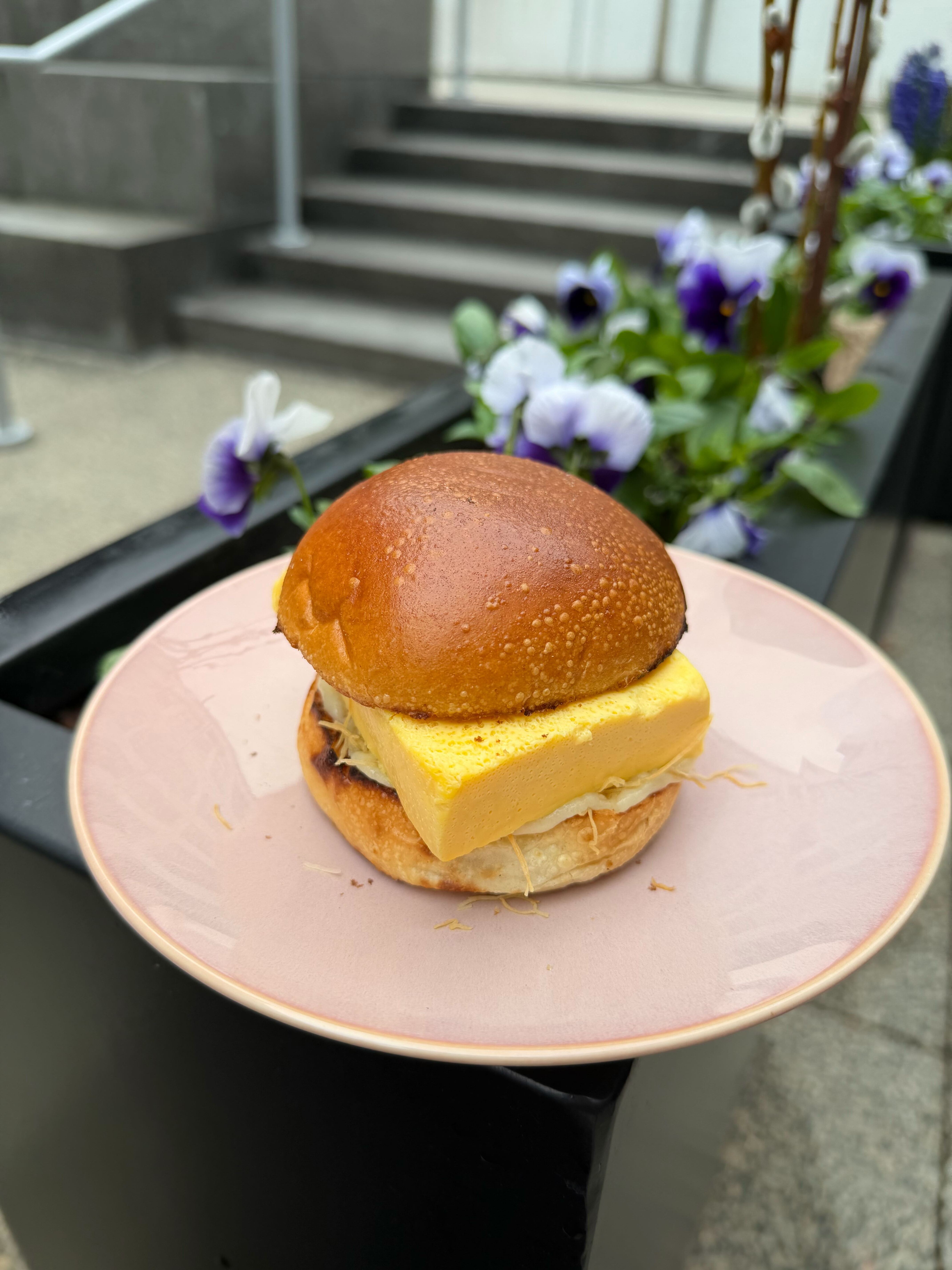 Breakfast sandwich on a pink plate