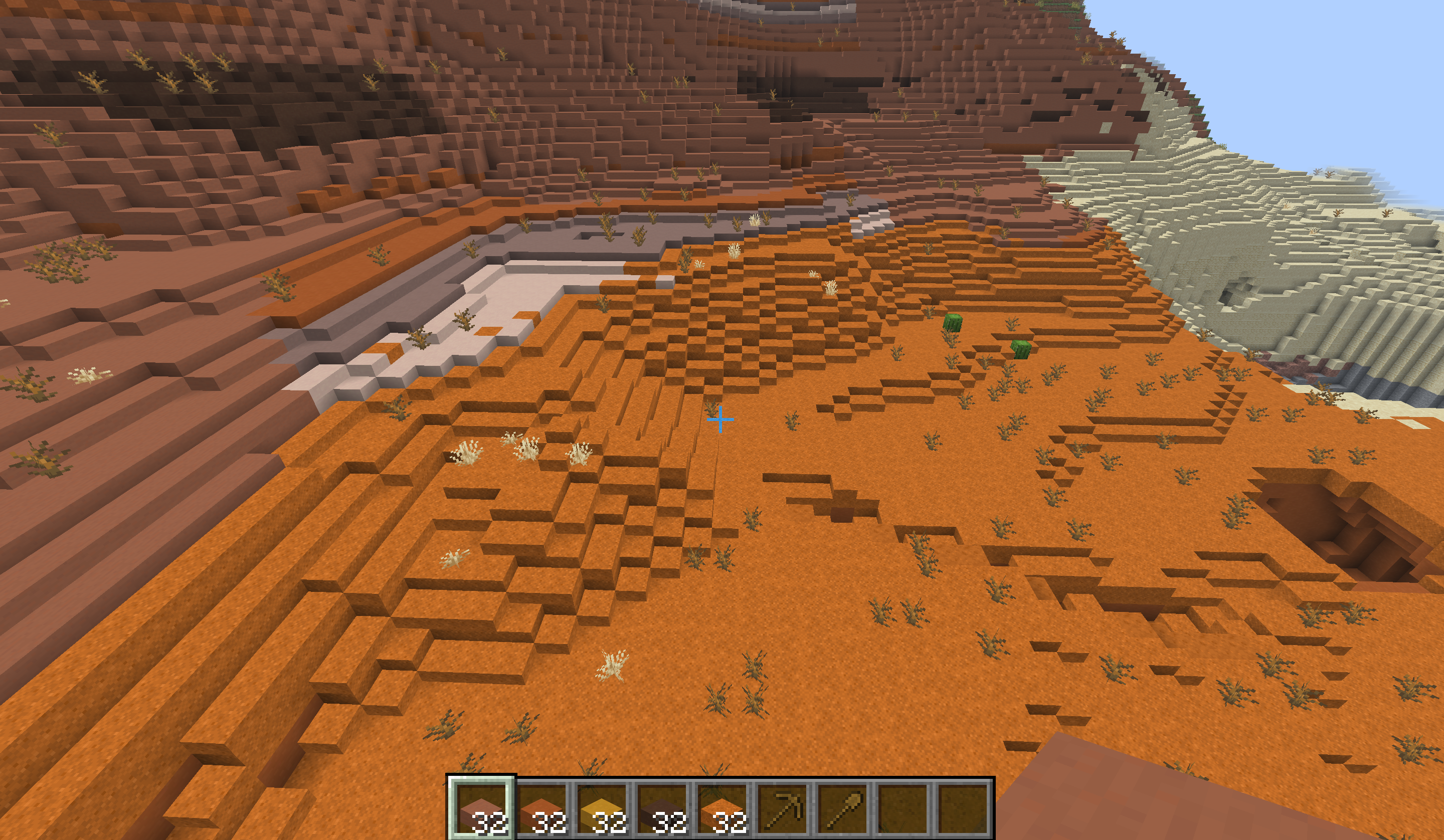 Badlands: red sand terraced with red sand slabs, and terracotta bands stepped with matching terracotta slabs