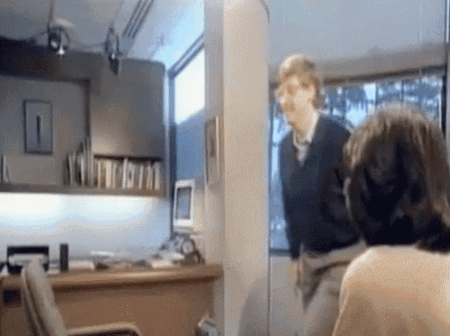 A young Bill Gates gracefully jumping over an office chair like a gazelle
