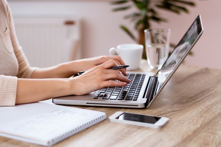 Healthcare professional reviewing insurance claims at computer