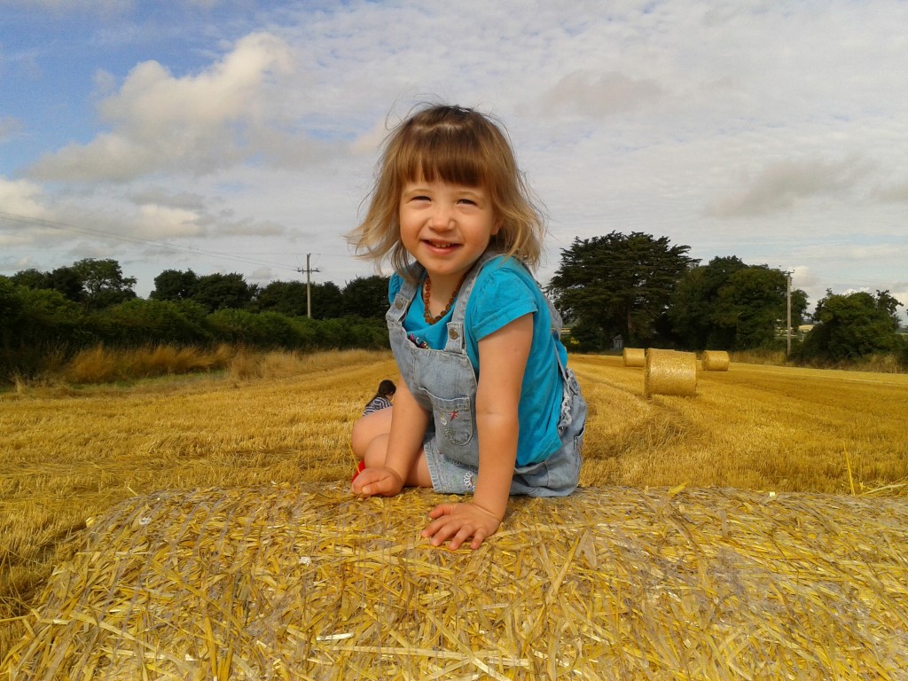 A child sitting in a field of wheat