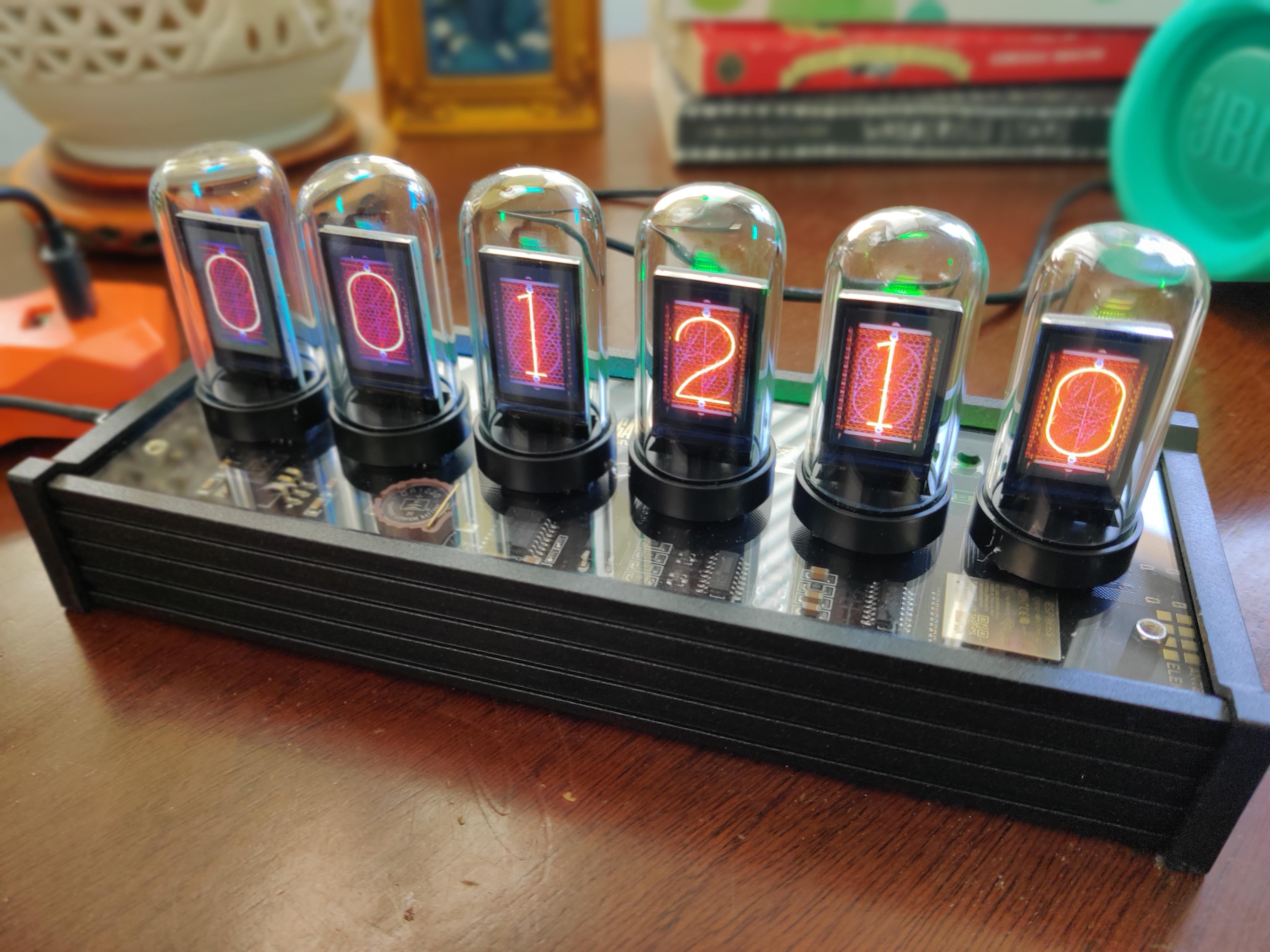 Photo of the EleksTube IPS sitting on a desktop displaying Nixie Tube images