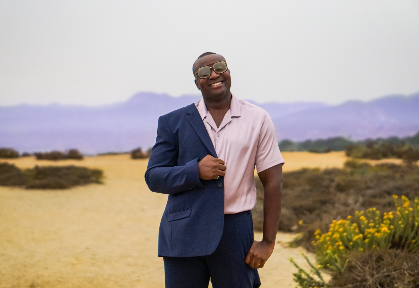 Steve Ryan wearing sunglasses in a navy suit