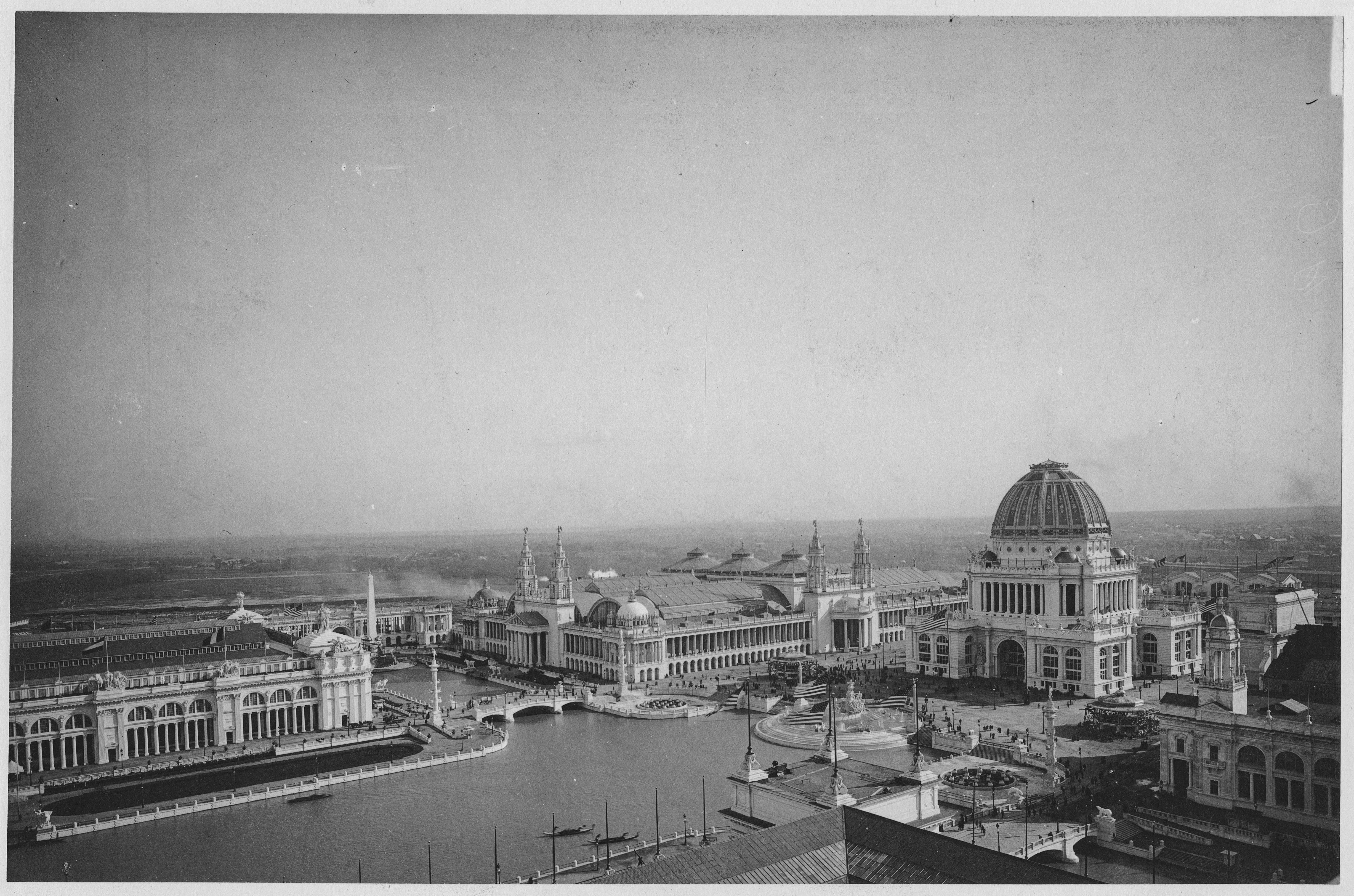 Black and White Photograph of Large Neoclassical Exhibition Buildings and a Domed Structure by a Canal (1893)