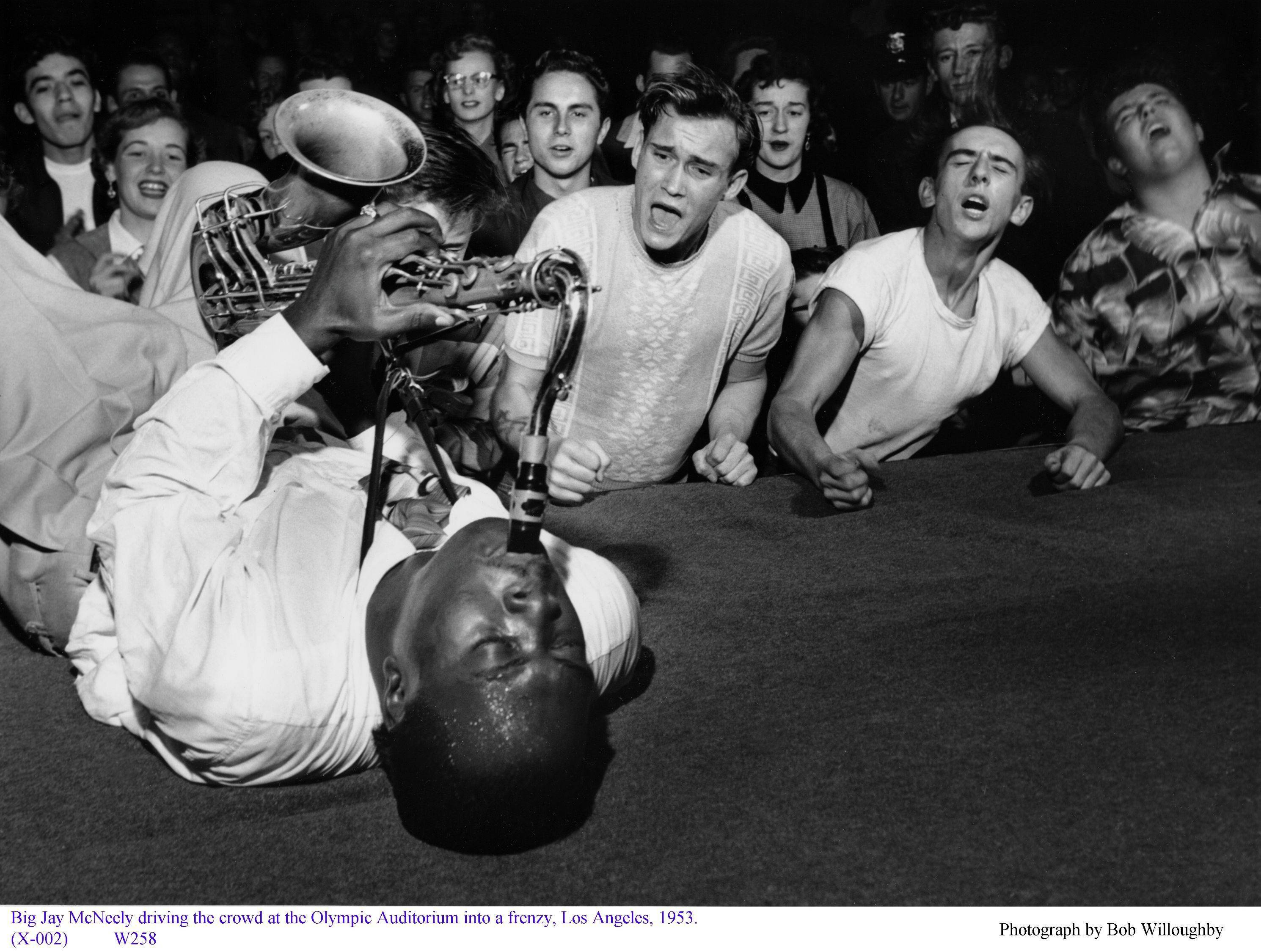 Big Jay McNeely driving the crowd at the Olympic Auditorium into a frenzy, Los Angeles by Bob Willoughby (1953)