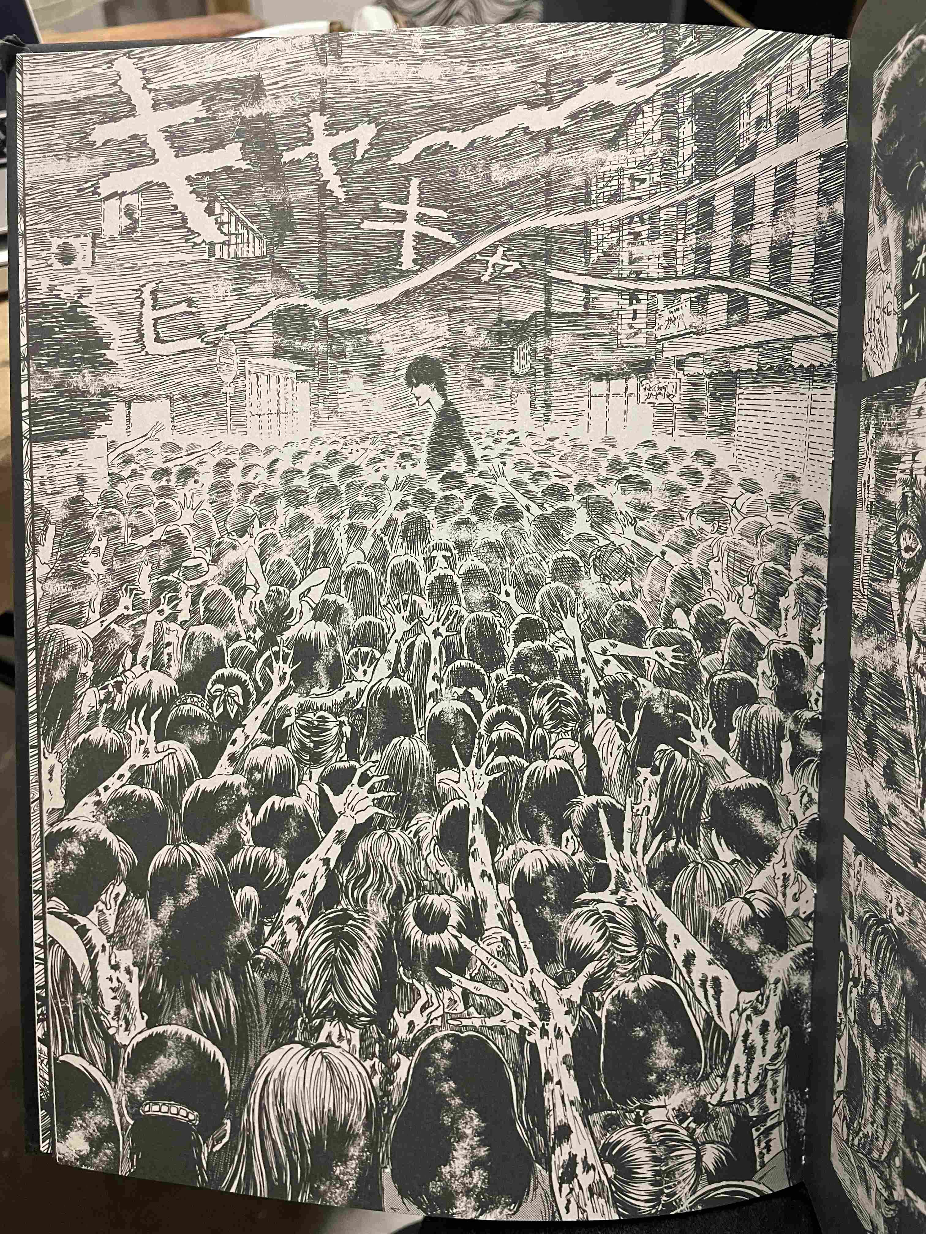 Black and White Illustration of a Figure Standing Above a Massive Crowd Reaching Up by Junji Ito (1998-1999)