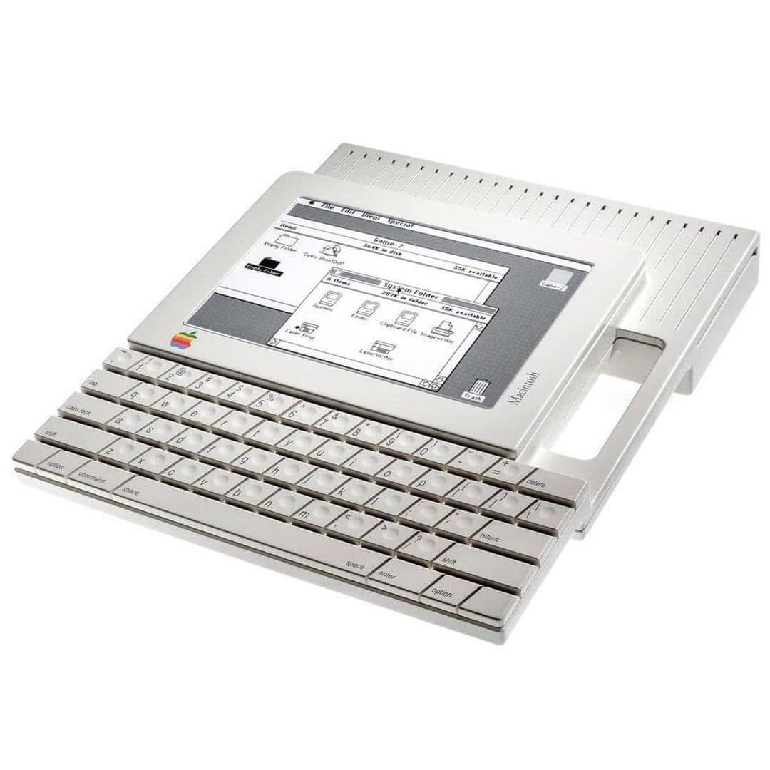 Photograph of a vintage Apple Macintosh Portable computer displaying the classic operating system interface