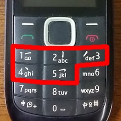 Picture of a dumbphone with stroke input method on keys 1 to 5.