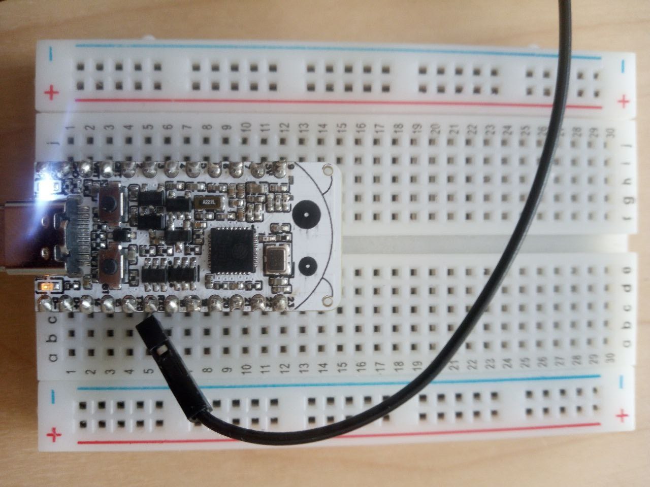 An ESP32-C6-Bug board with its onboard LED lit.