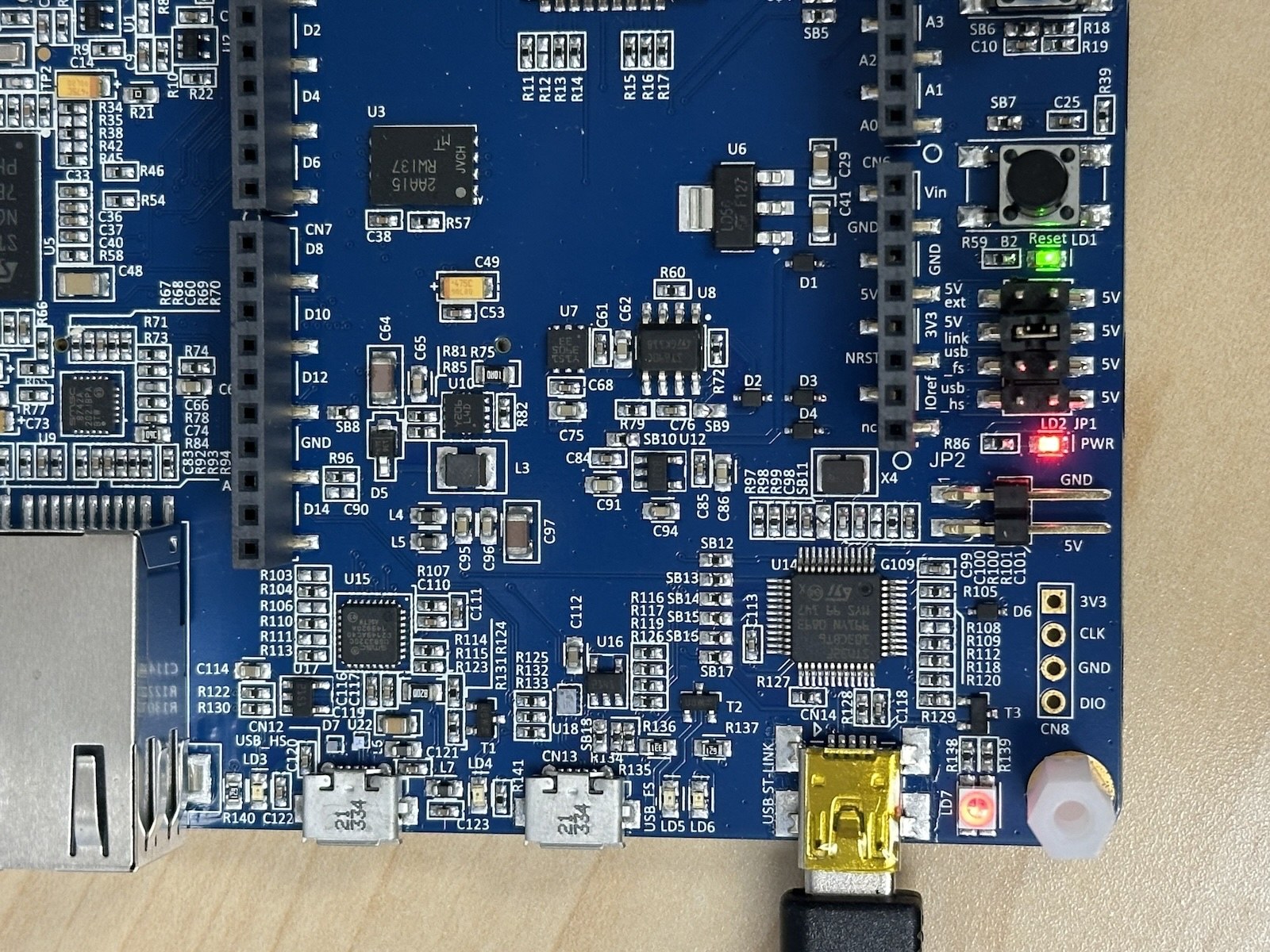 An STM32F746G-DISCO board with its onboard LED lit.