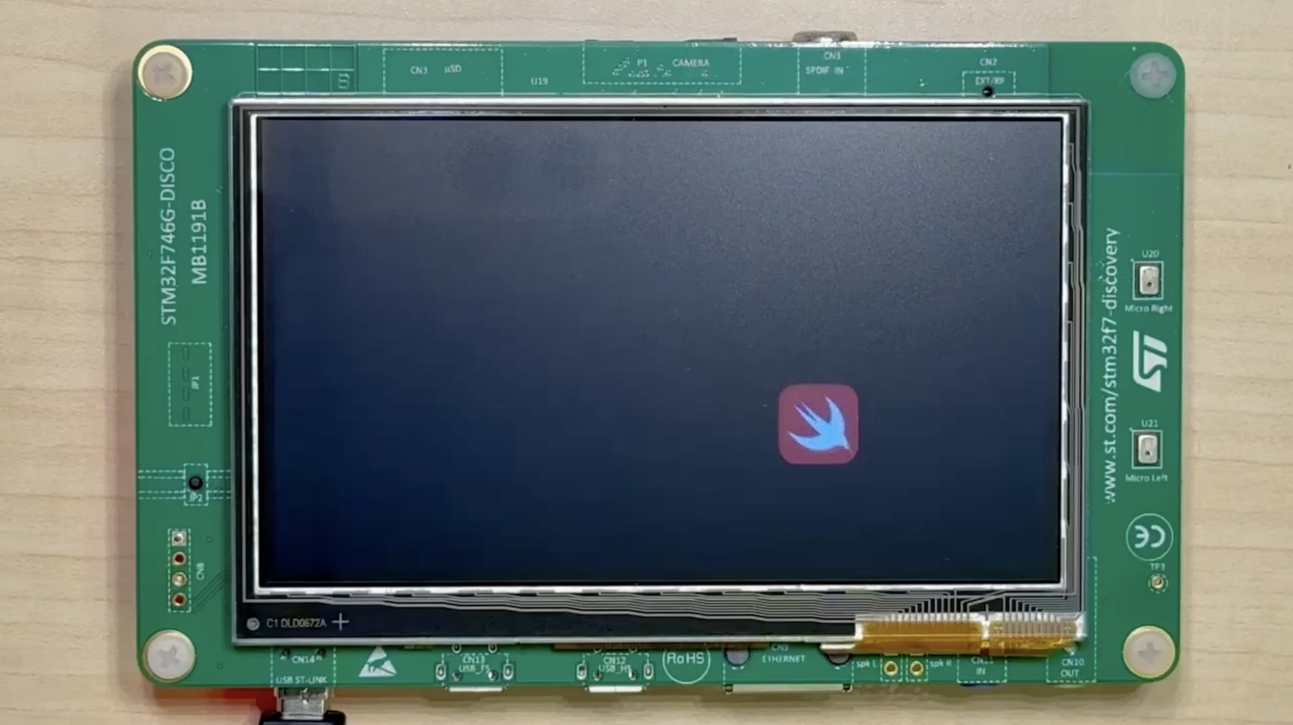 A Swift logo rendered on the STM32F746G-DISCO's onboard LCD panel.