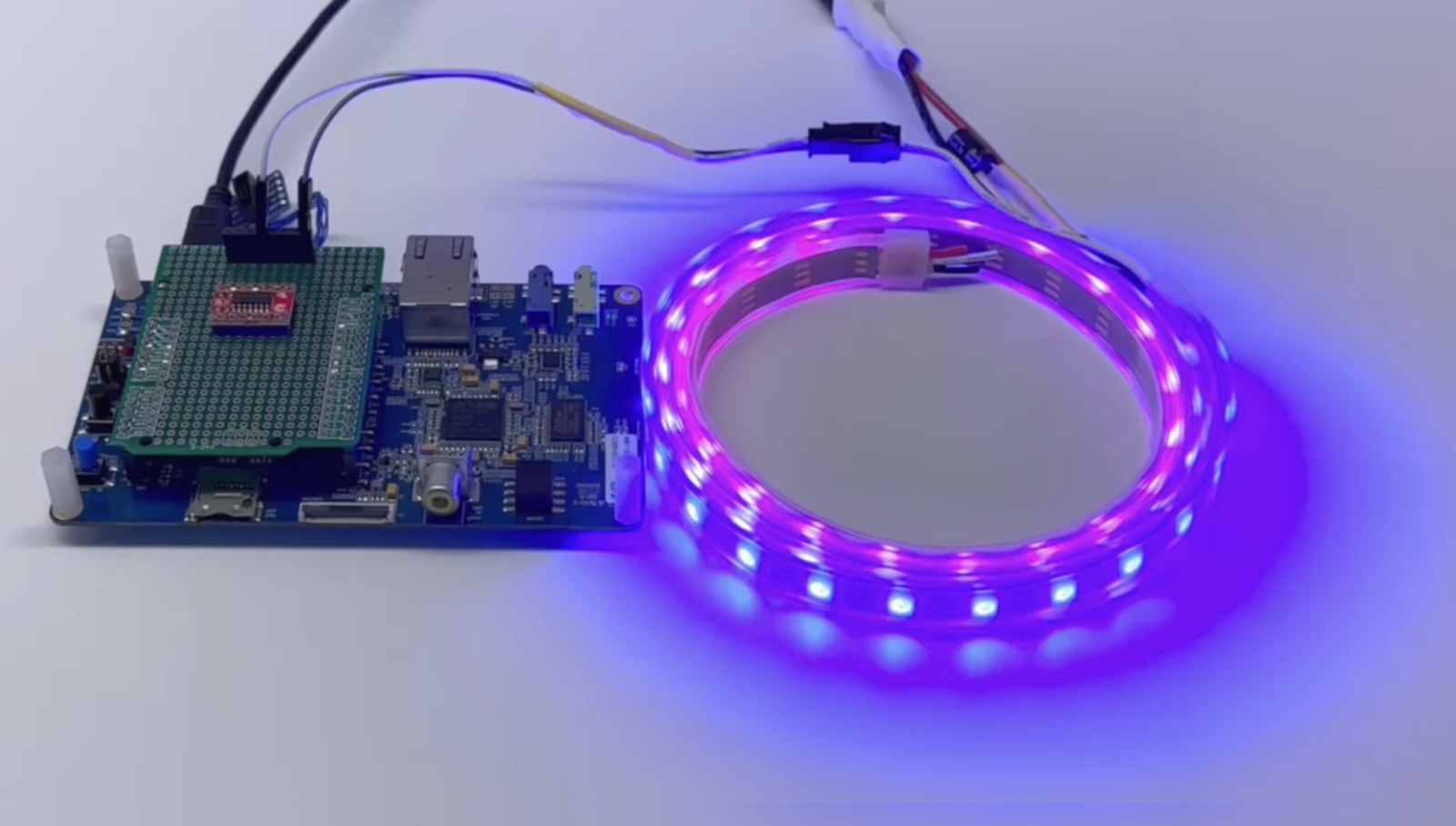 An STM32F746G-DISCO board driving a lit WS2812 NeoPixel LED strip.