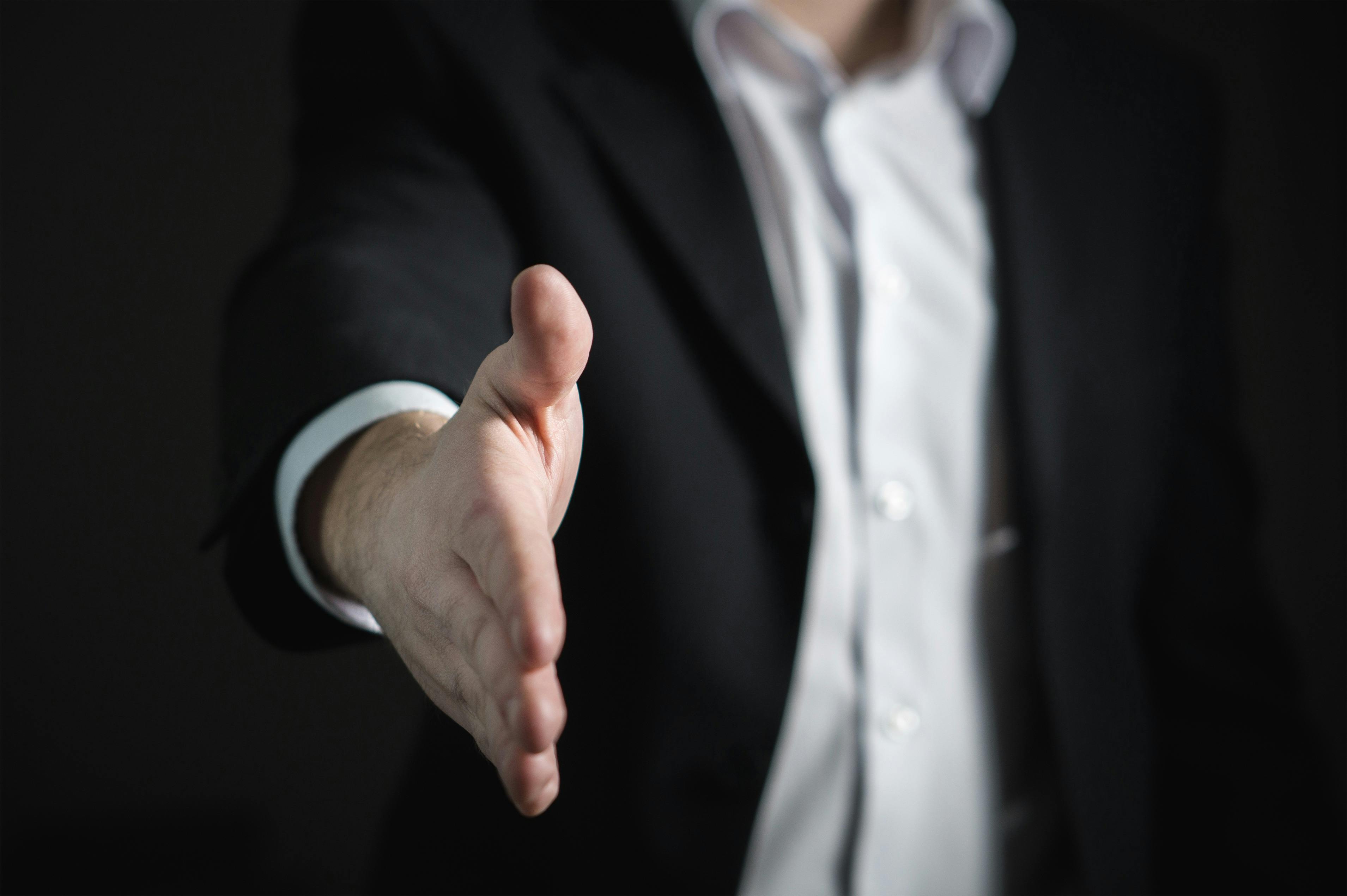 hiring manager extending his hand to shake yours