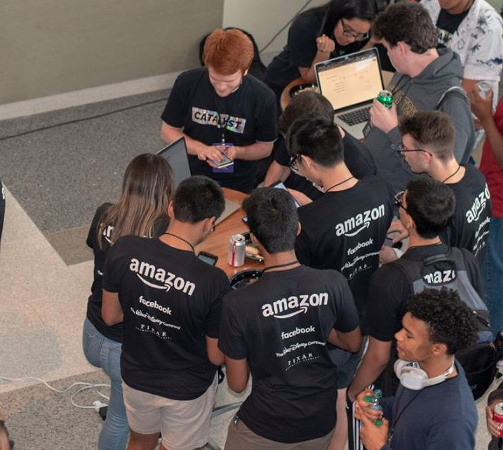 Students crowded around a table to play Cookie Externalities