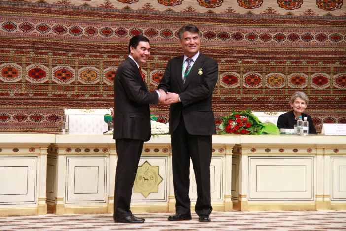 "Tashpolat Tiyip accepting an award from the president of Turkmenistan"