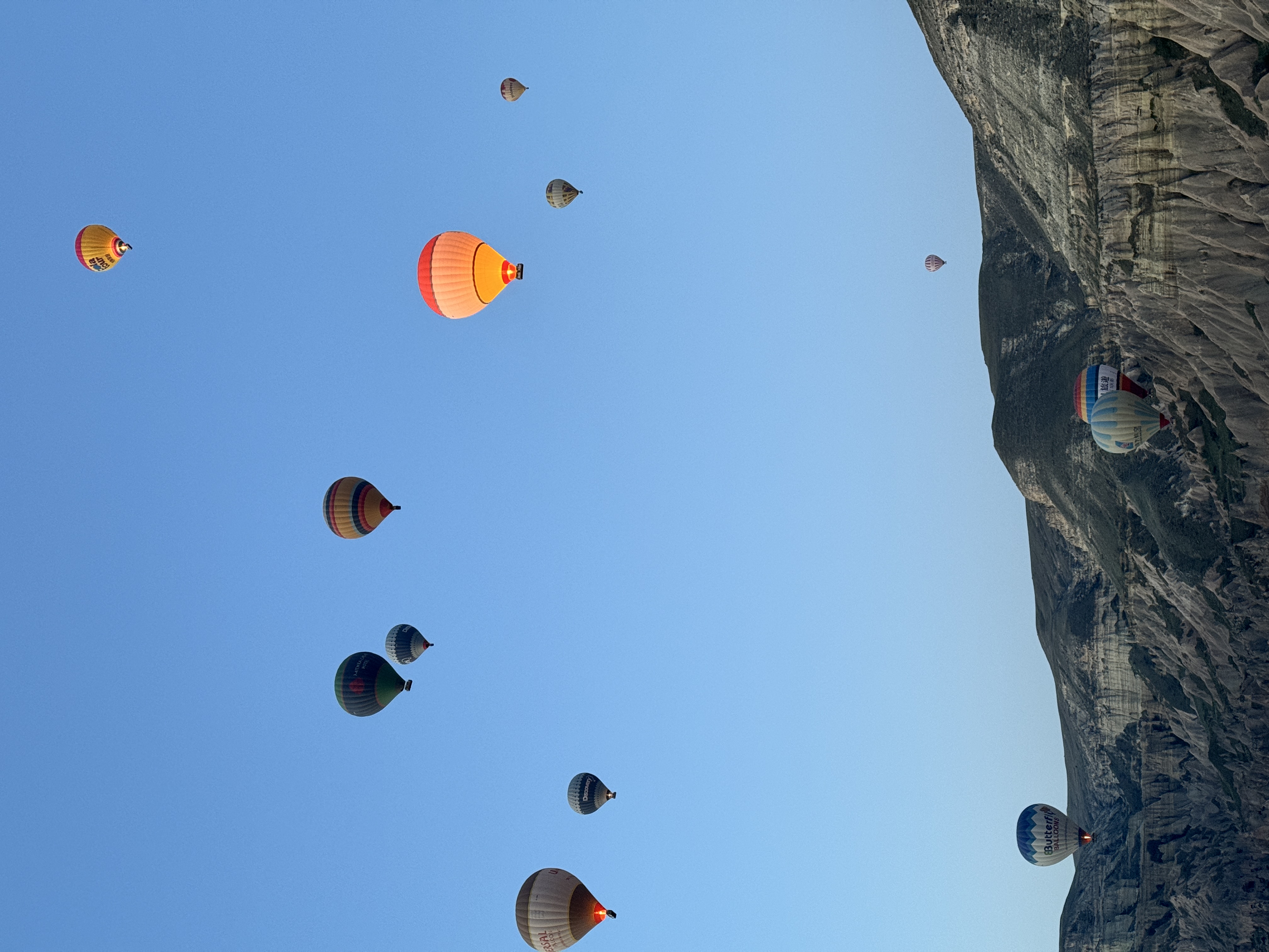 Hot air balloons over Cappadocia valleys at dawn, Turkey