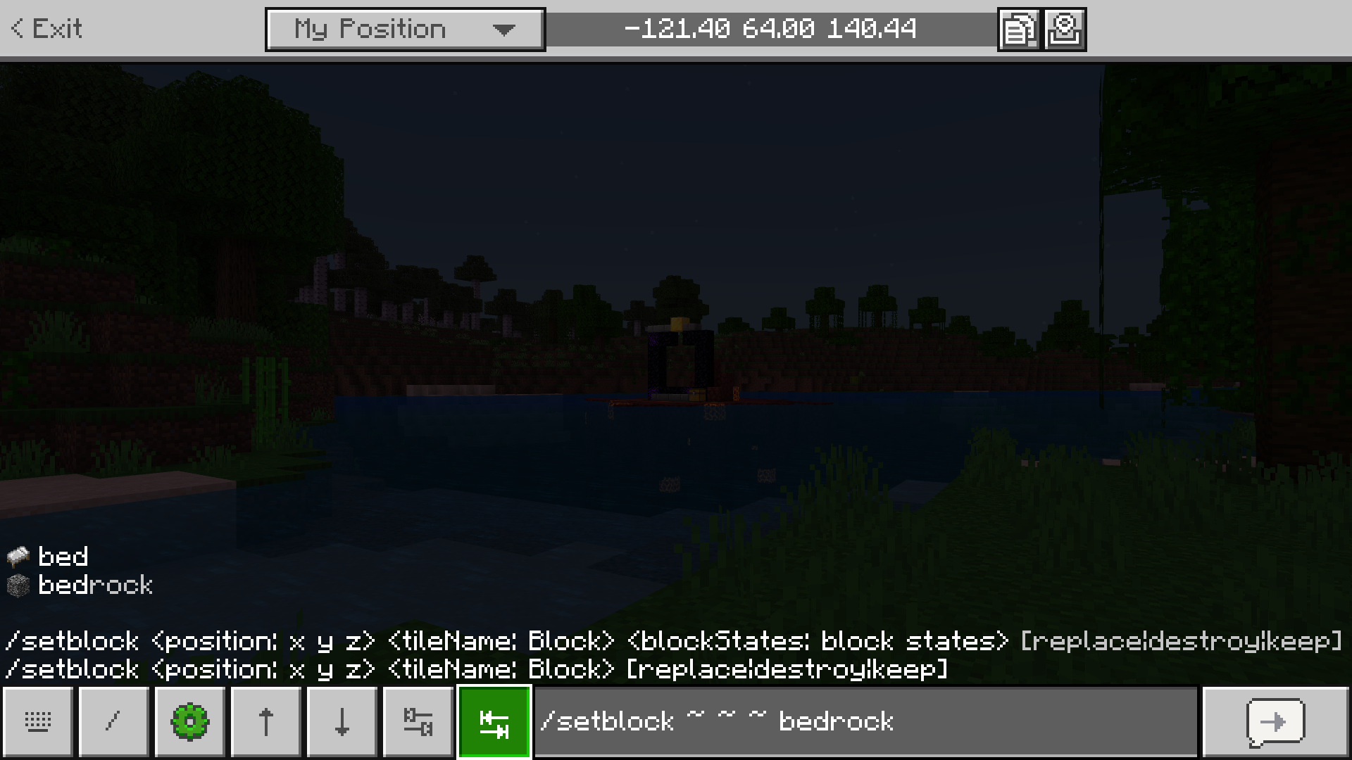 In-game screenshot showcasing the autocomplete feature. Text box content reads, “/setblock ~ ~ ~ bedrock”.