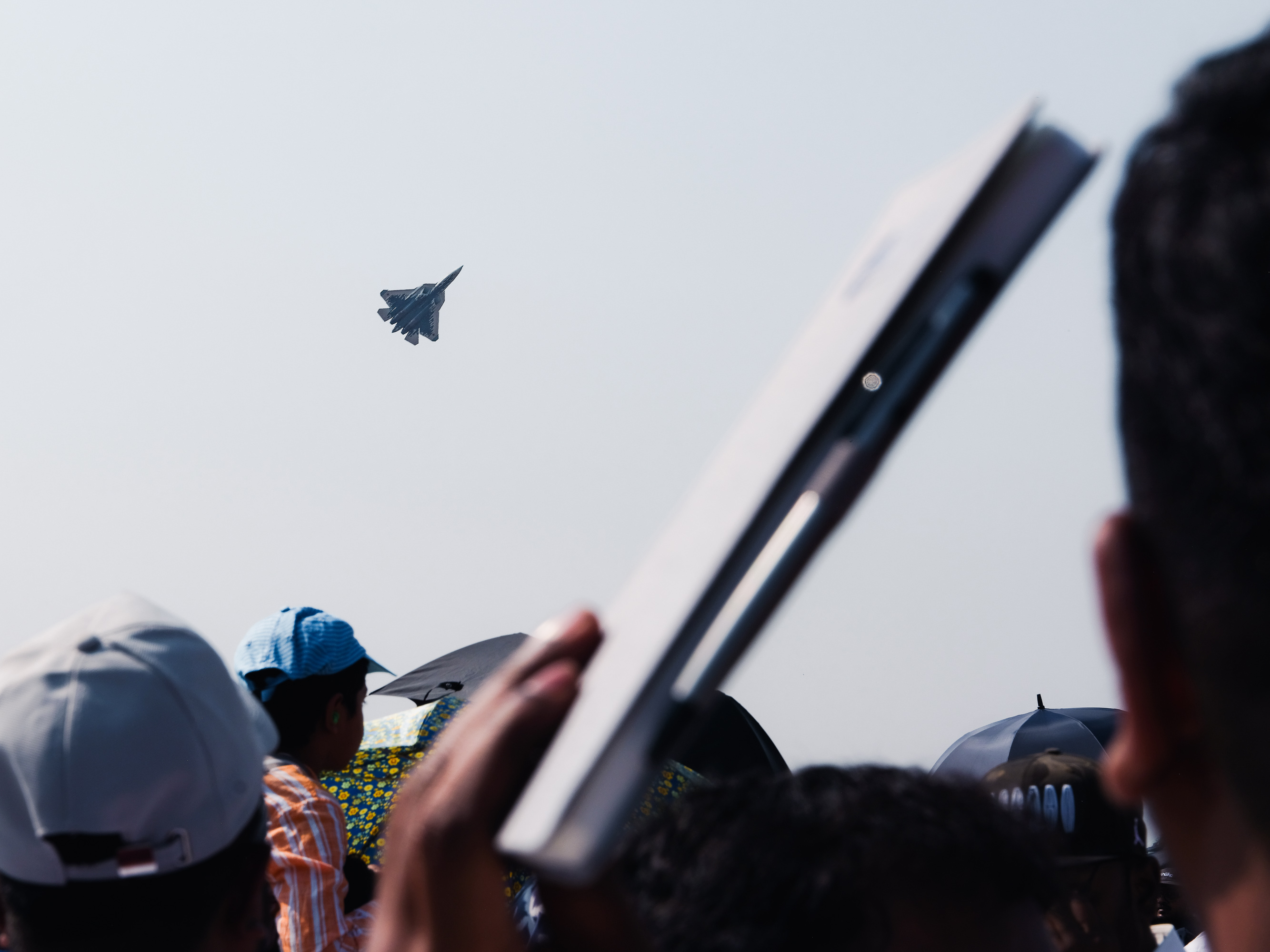 Crowds watch the Sukhoi SU-57 in performance at Aero India. Yelahanka (Under Construction – Blue Line)