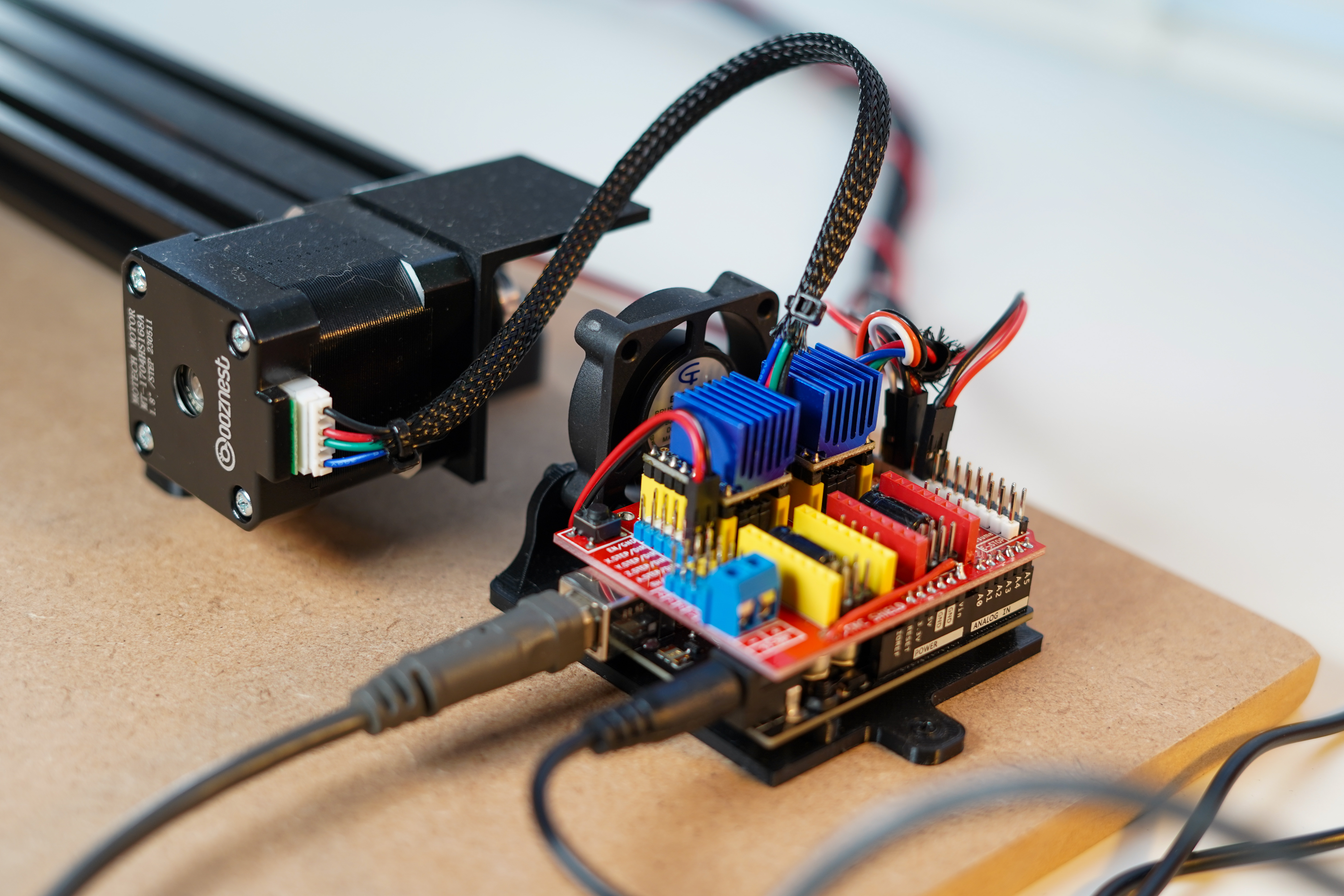 3D printed bracket holding arduino and cnc shield with fan