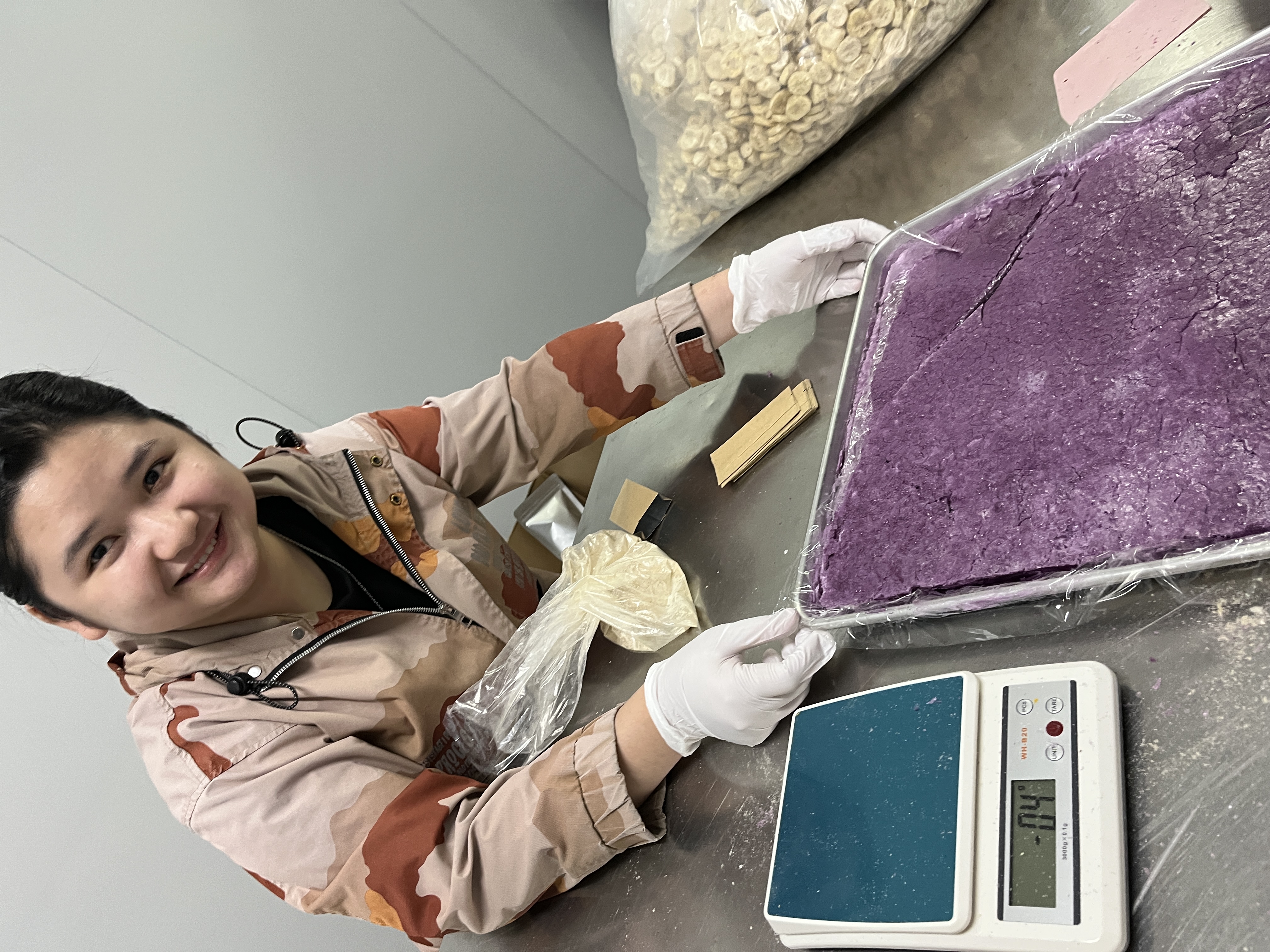 Quality check — TKG Naula weighing and testing botanical powder