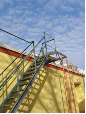 Photo of stairs up the side of a yellow building