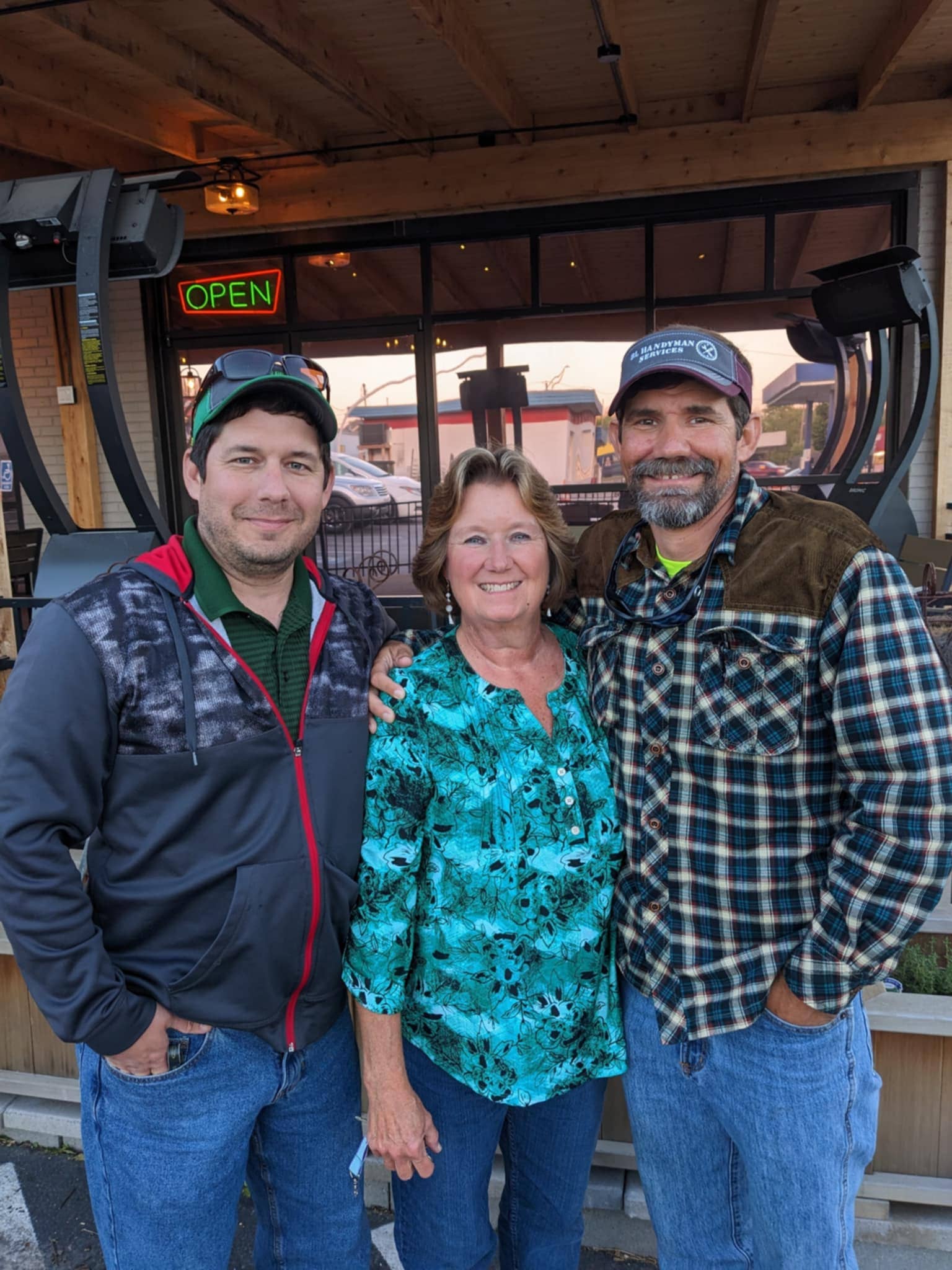 Adam Lazenby enjoying a meal with his brother and mother at a restaurant, demonstrating the importance of family time