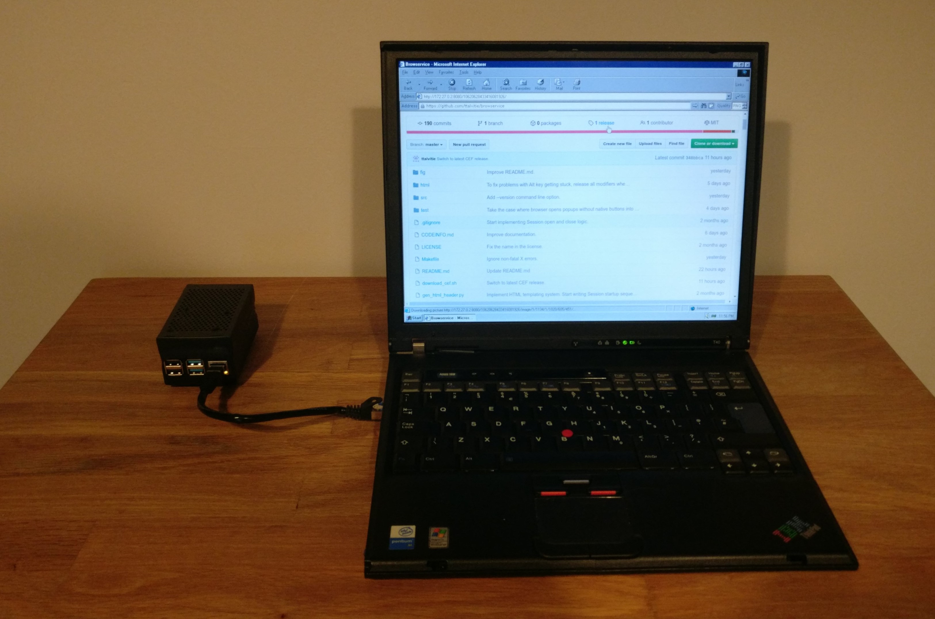 Photo of ThinkPad T40 showing a GitHub page, and a Raspberry Pi 4 running the Browservice proxy connected to the laptop with an Ethernet patch cable