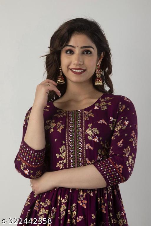 A wine Anarkali border print kurti with tassels sounds like a beautiful and stylish outfit choice Anarkali style kurtas are known for their flowing and flared silhouette, which adds an elegant touch to your look.Charvi Superior Kurtis - ARYAMI