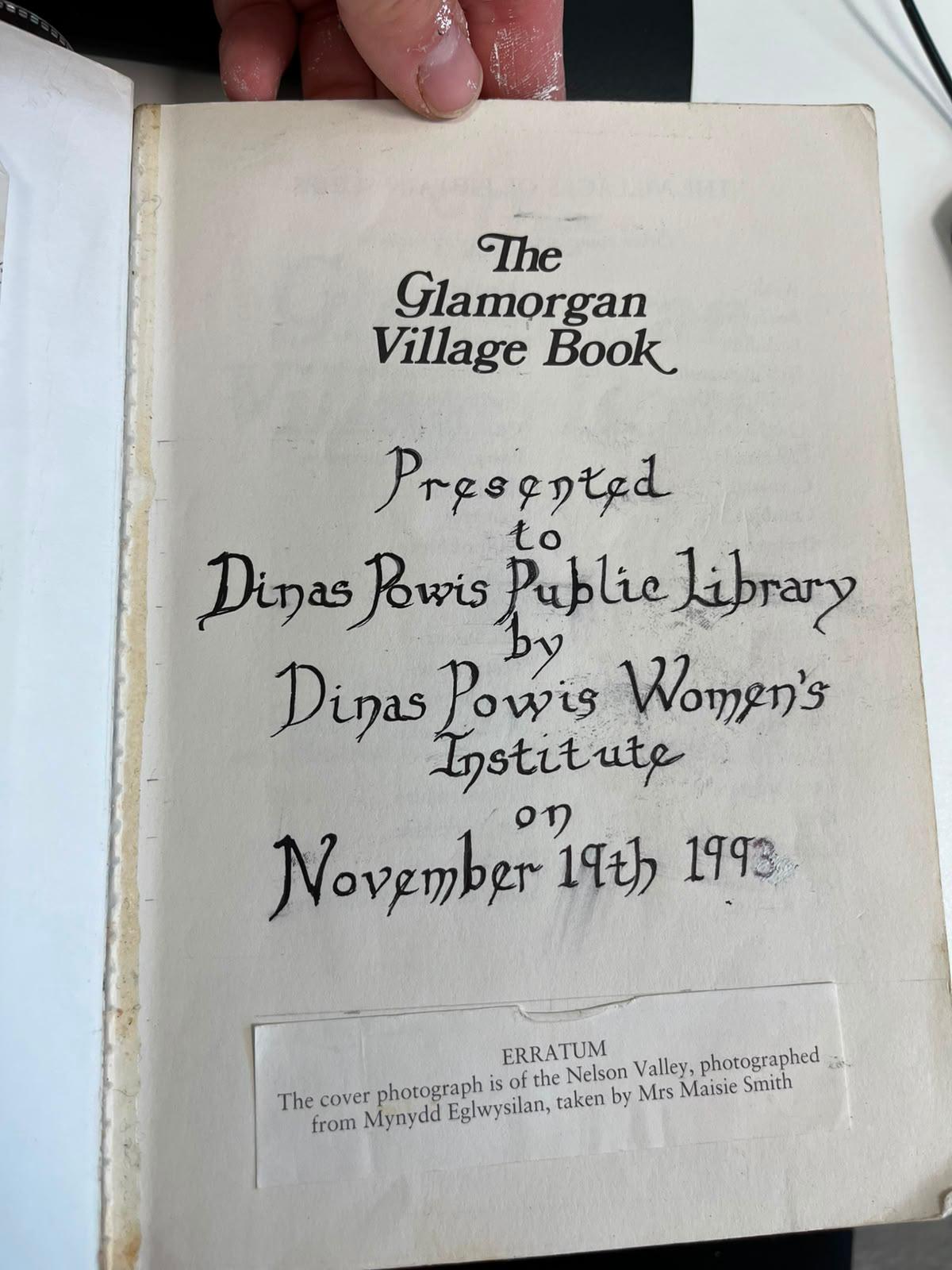 Photograph of the title/presentation page of The Glamorgan Village Book, with a handwritten presentation note to Dinas Powis Public Library dated 19 November 1993.