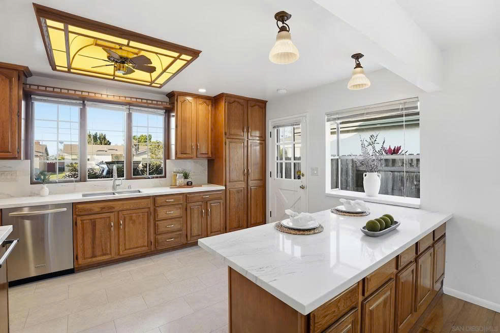 Kitchen with marble countertops, oak cabinetry, and center island