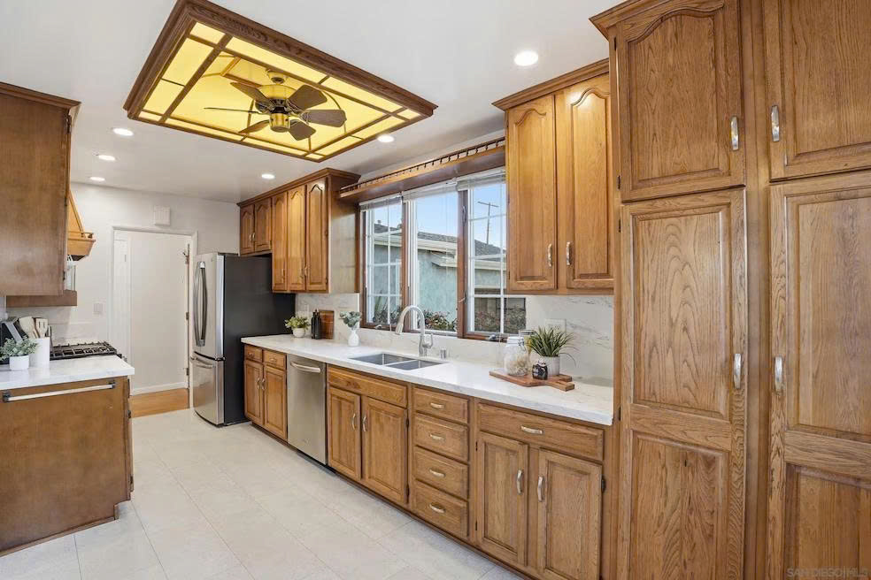 Kitchen detail with full-height pantry, countertops, and window