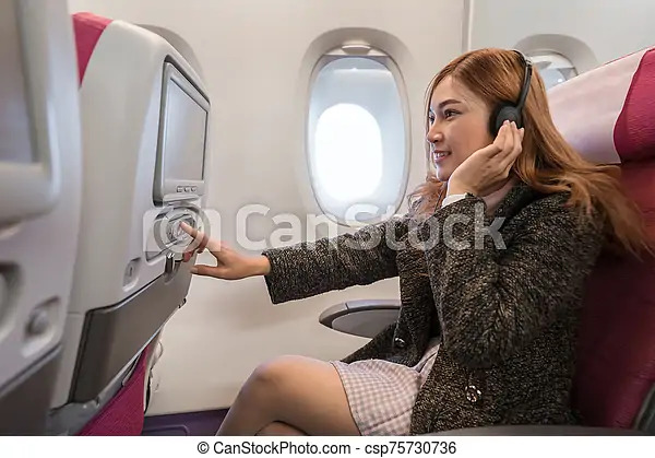 A woman that "might" be playing 2048 on the airplane's infotainment system