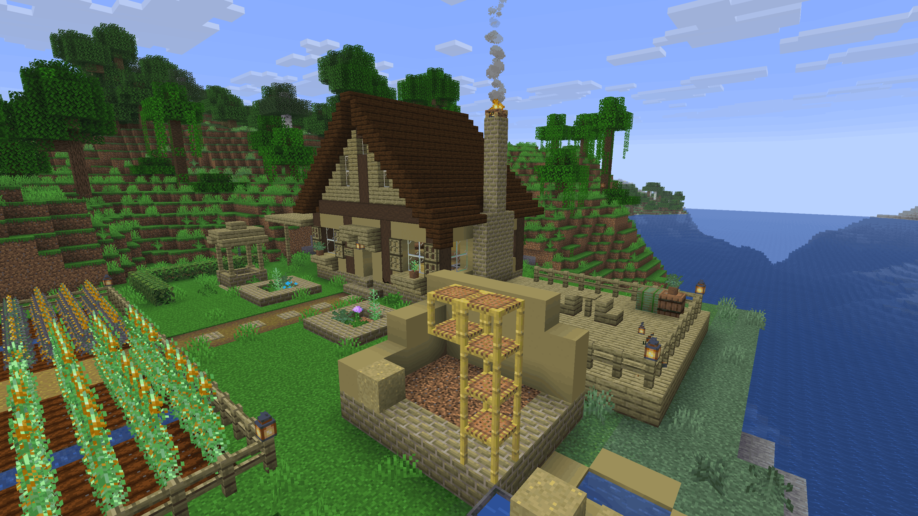 The same house from the side, with a hempcrete wall, a hemp-plank deck and a hemp bale by the barrels