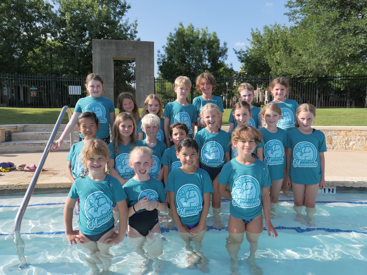 Mueller Manatees swimmers celebrating as a group.