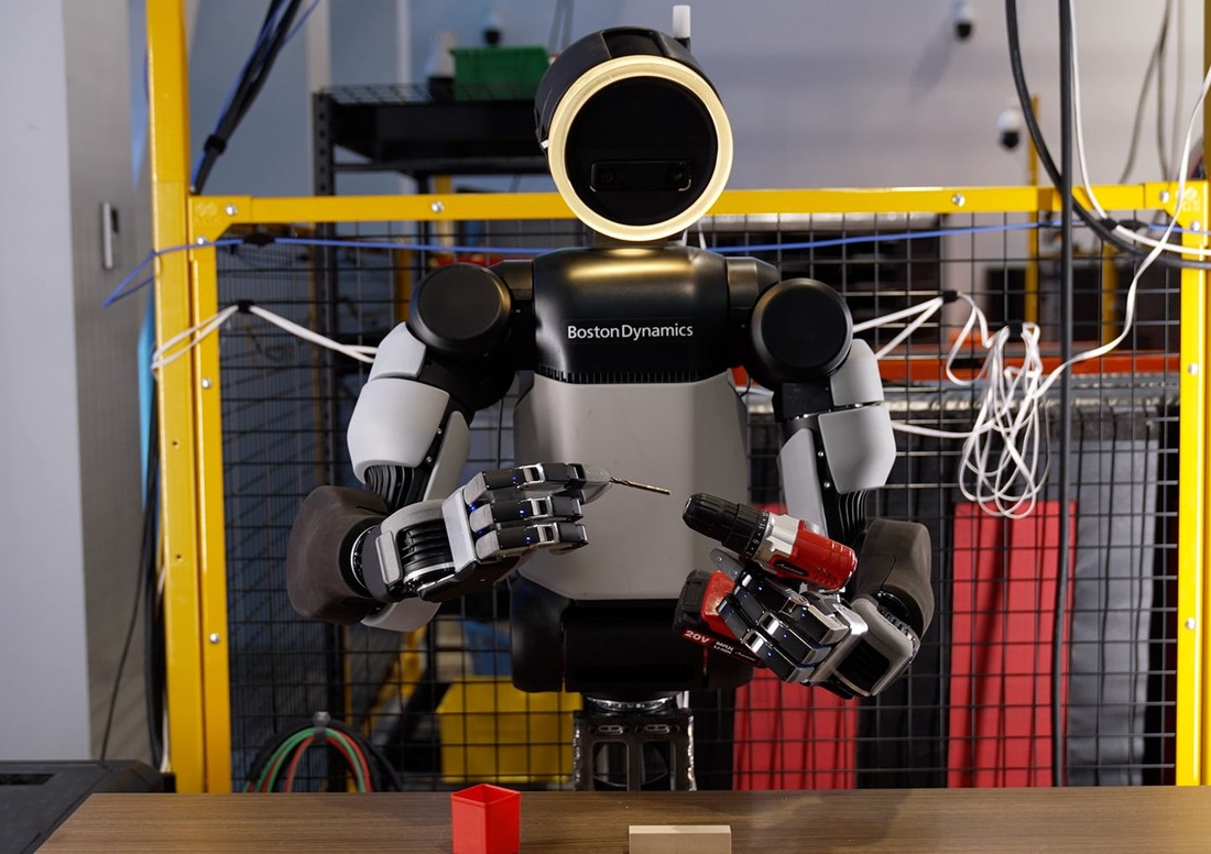 Atlas holds a power drill and a drill bit in its new robotic hands