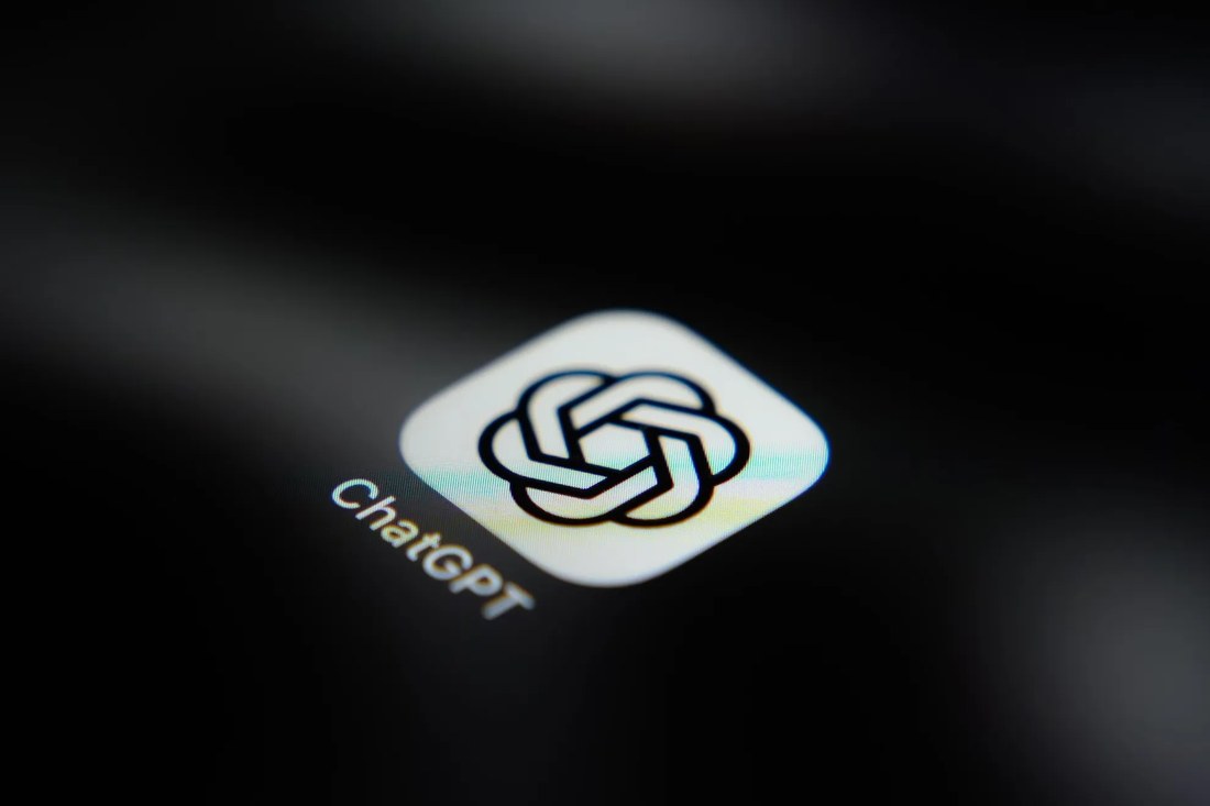 Close-up photograph of the ChatGPT app icon on a dark screen