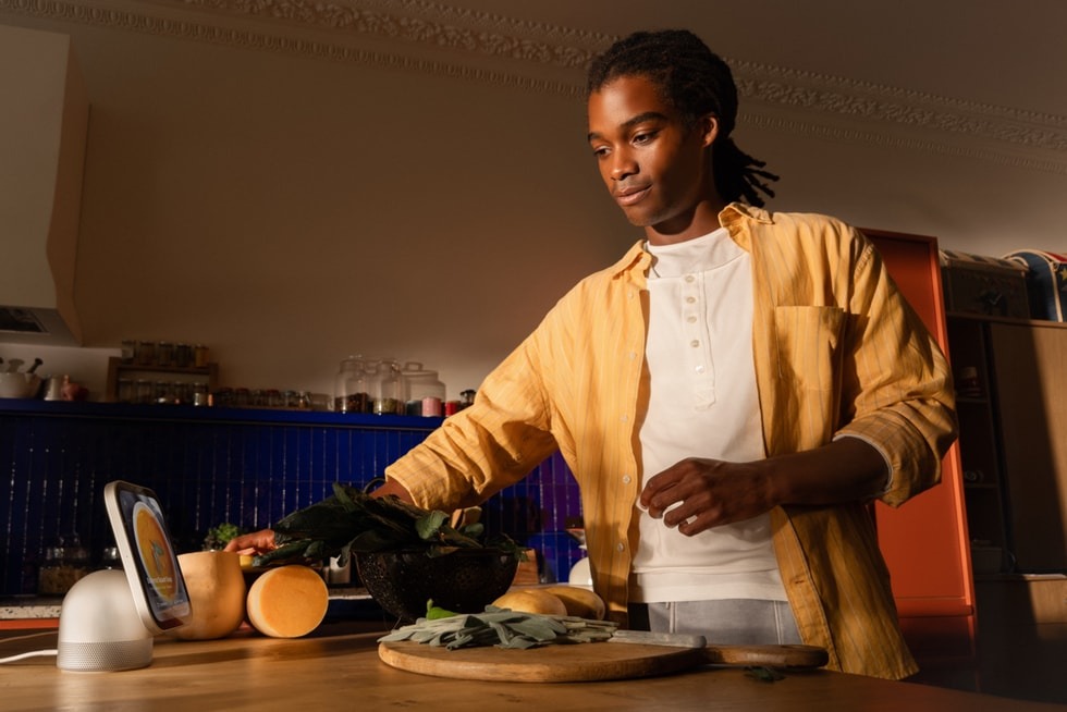 Apple HomeView on a kitchen counter beside someone preparing food
